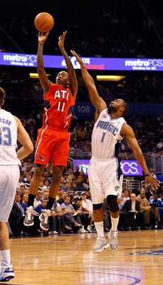 ORLANDO, FL - APRIL 16:  Jamal Crawford #11 of the Atlanta Hawks shoots over Gilbert Arenas #1 of the Orlando Magic during Game One of the Eastern Conference Quarterfinals of the 2011 NBA Playoffs on April 16, 2011 at the Amway Arena in Orlando, Florida.