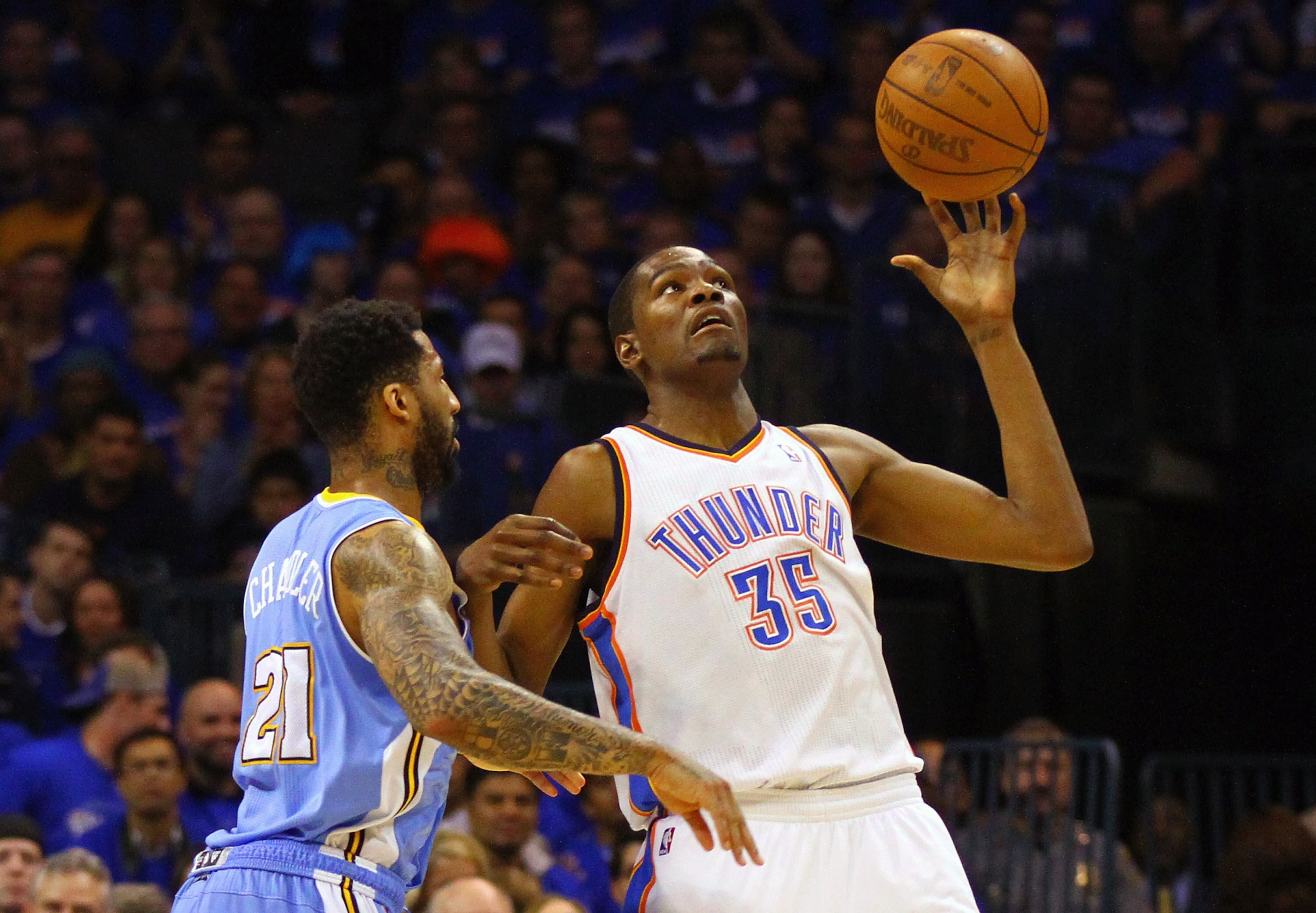 OKLAHOMA CITY, OK - APRIL 20: Kevin Durant #35 of the Oklahoma City Thunder looks to hold on to a pass \\against Wilson Chandler #21 of the Denver Nuggets in Game Two of the Western Conference Quarterfinals in the 2011 NBA Playoffs on April 20, 2011 at th