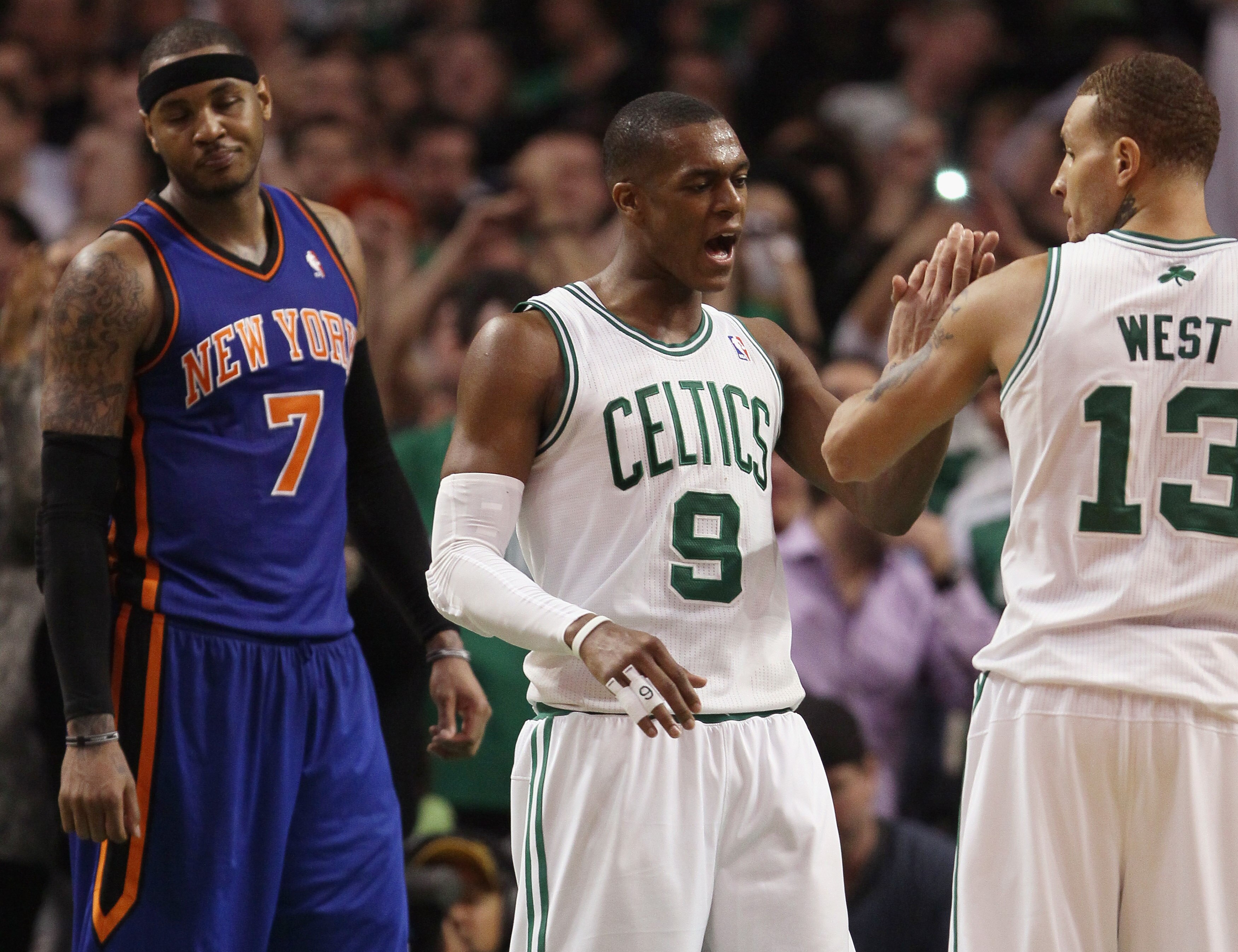 BOSTON, MA - APRIL 19:  Rajon Rondo #9 of the Boston Celtics congratulates Delonte West #13 after he made a free throw with .6 seconds left in the game as Carmelo Anthony #7 of the New York Knicks reacts in Game Two of the Eastern Conference Quarterfinals