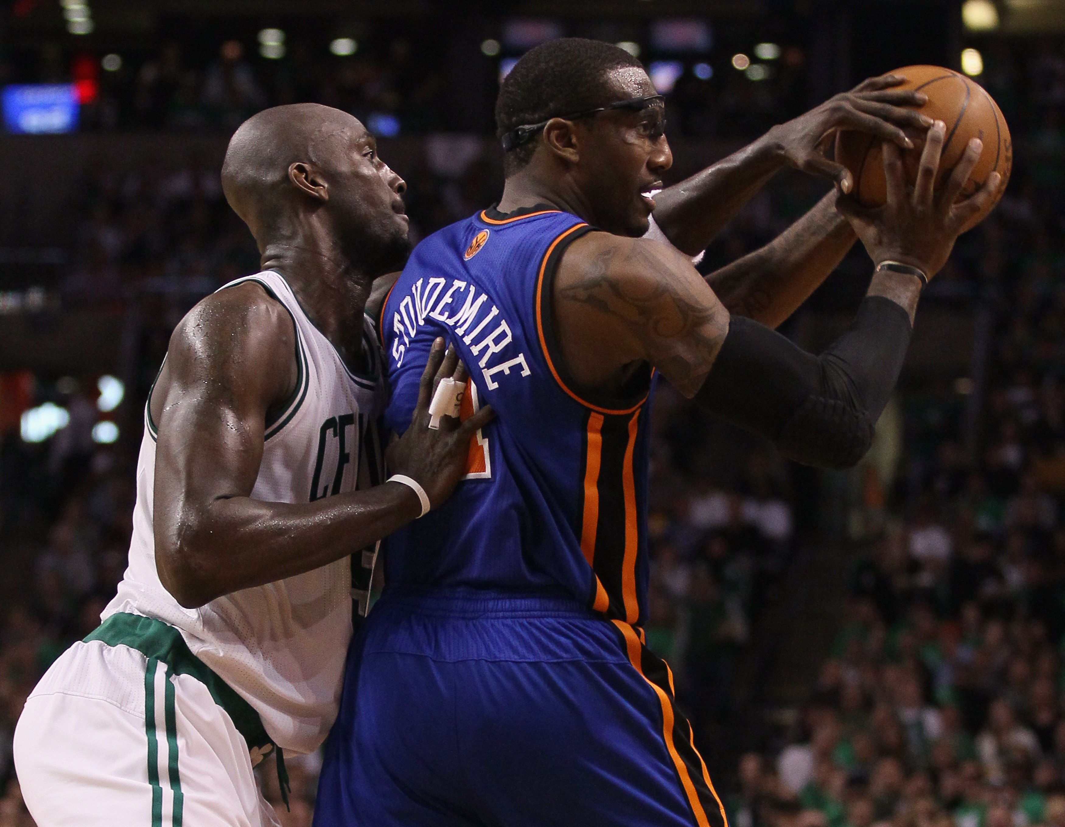 BOSTON, MA - APRIL 17:  Kevin Garnett #5 of the Boston Celtics tries to knock the ball away from Amare Stoudemire #1 of the New York Knicks   in Game One of the Eastern Conference Quarterfinals in the 2011 NBA Playoffs on April 17, 2011 at the TD Garden i