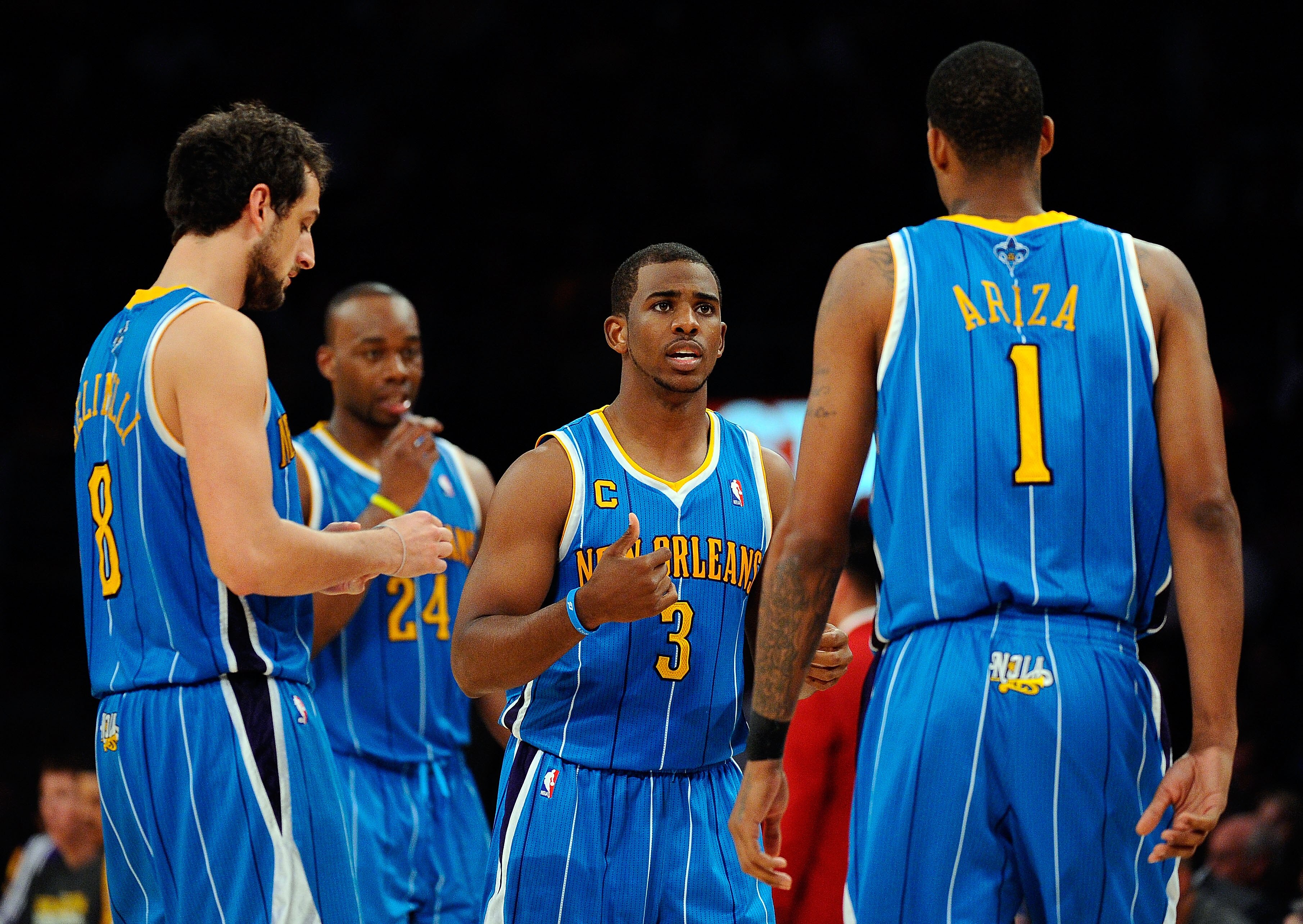 LOS ANGELES, CA - APRIL 20:  (C) Chris Paul #3 of the New Orleans Hornets talks with teammates Marco Belinelli #8 and Trevor Ariza #1 while taking on the Los Angeles Lakers in Game Two of the Western Conference Quarterfinals in the 2011 NBA Playoffs on Ap