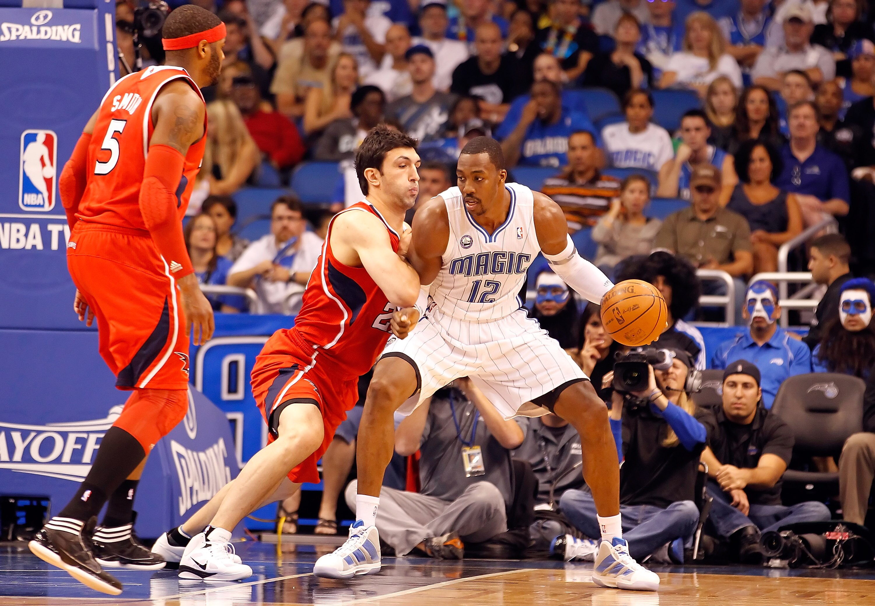 ORLANDO, FL - APRIL 19:  Dwight Howard #12 of the Orlando Magic drives as Zaza Pachulia #27 of the Atlanta Hawks defends during Game Two of the Eastern Conference Quarterfinals of the 2011 NBA Playoffs on April 19, 2011 at the Amway Arena in Orlando, Flor