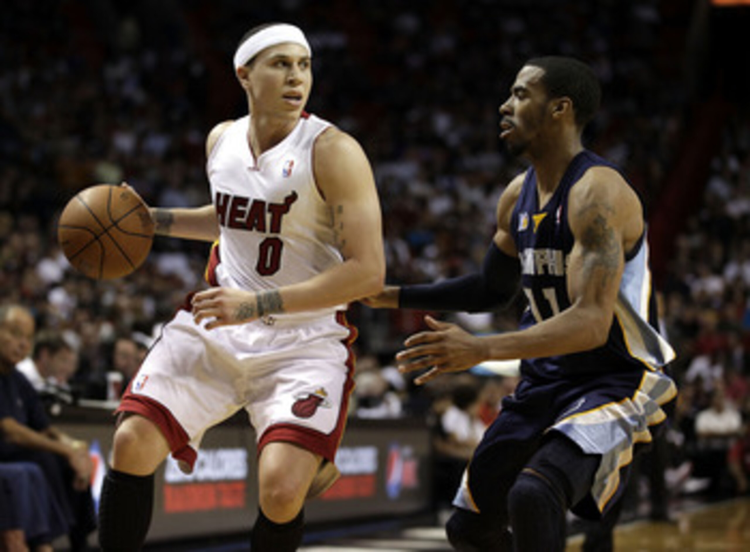 MIAMI - MARCH 12: Guard Mike Bibby #0 of the Miami Heat (L) drives the ball against Guard Mike Conley #11 of the Memphis Grizzlie at American Airlines Arena on March 12, 2011 in Miami, Florida. NOTE TO USER: User expressly acknowledges and agrees that, b MIAMI - MARCH 12: Guard Mike Bibby #0 of the Miami Heat (L) drives the ball against Guard Mike Conley #11 of the Memphis Grizzlie at American Airlines Arena on March 12, 2011 in Miami, Florida. NOTE TO USER: User expressly acknowledges and agrees that, b