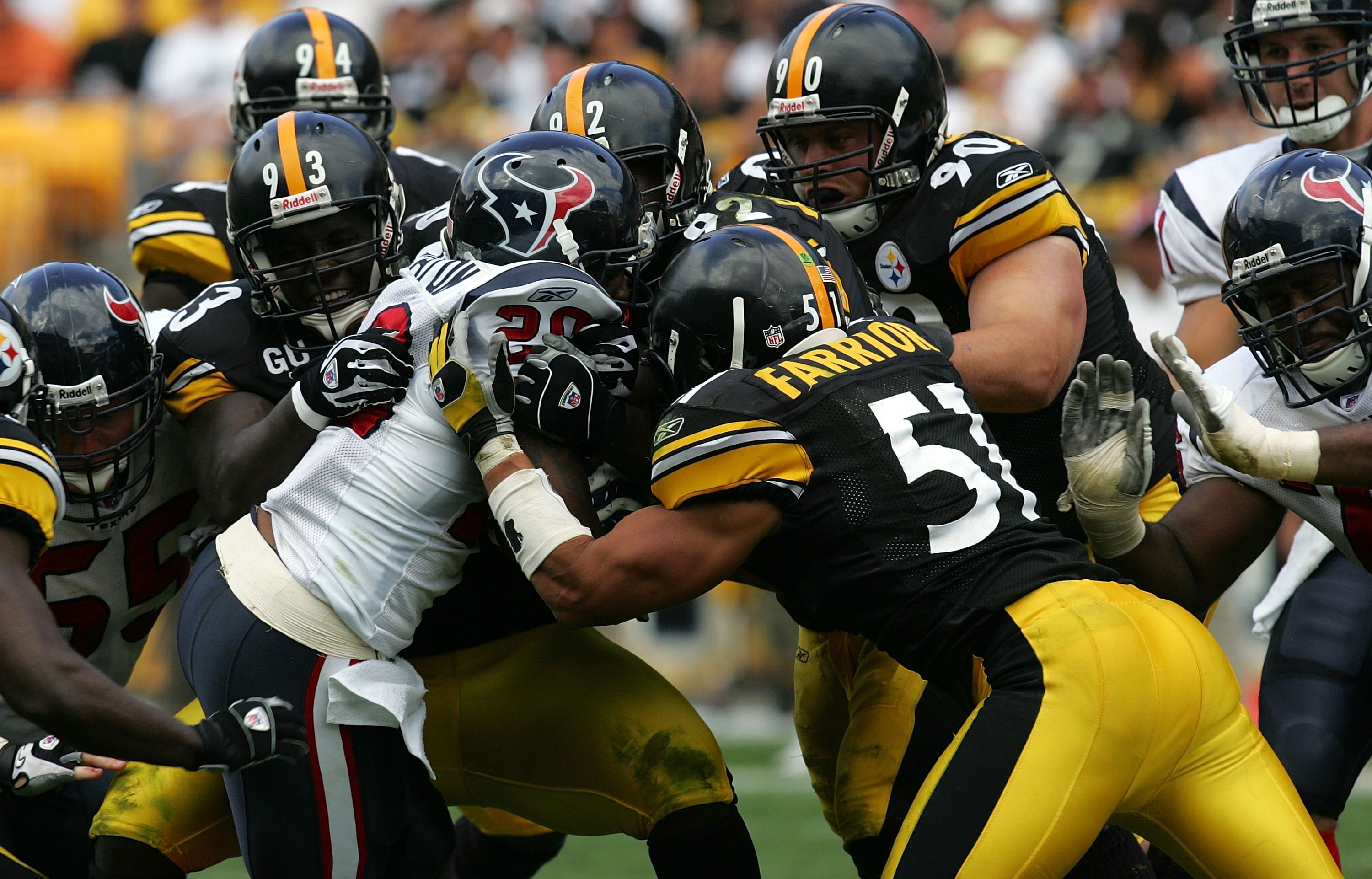 PITTSBURGH - SEPTEMBER 07:  Running back Steve Slaton #20 of the Houston Texans is tackled by Nick Eason #93, Lawrence Timmons #94, James Harrison #92, Travis Kirschke #90 and James Farrior #51 of the Pittsburgh Steelers on September 7, 2008 at Heinz Fiel