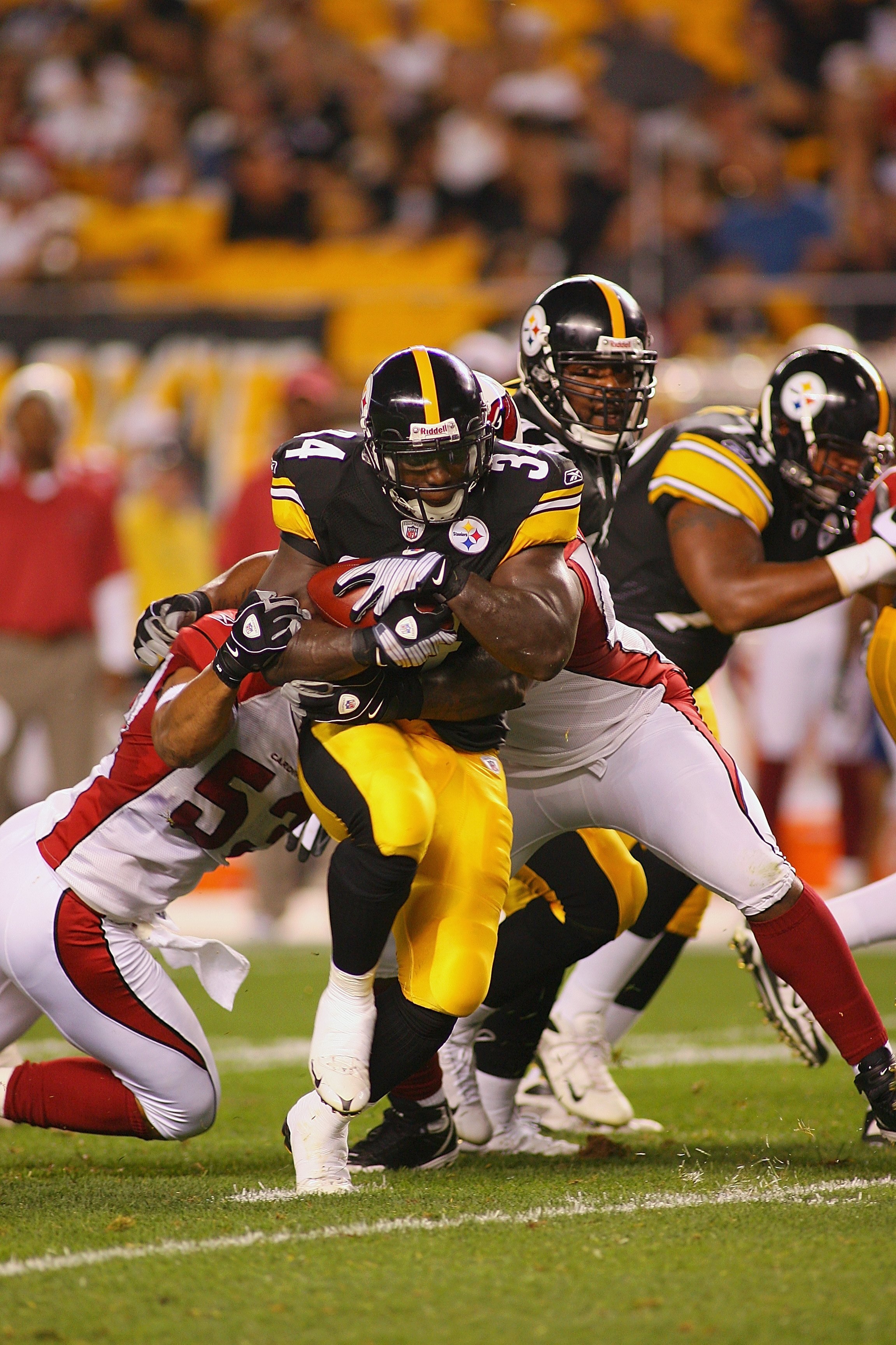 PITTSBURGH - AUGUST 13:  Rashard Mendenhall #34 of the Pittsburgh Steelers breaks a tackles from Clark Haggans of the Arizona Cardinals during the preseason NFL game at Heinz Field on August 13, 2009 in Pittsburgh, Pennsylvania.  The Steelers won 20-10.