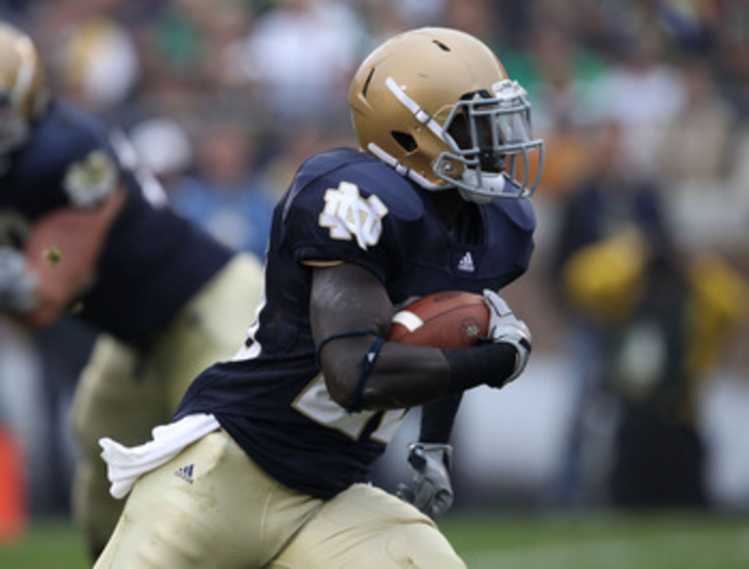 SOUTH BEND, IN - SEPTEMBER 11: Cierre Wood #20 of the Notre Dame Fighting Irish runs against Michigan Wolverine tacklers at Notre Dame Stadium on September 11, 2010 in South Bend, Indiana. Michigan defeated Notre Dame 28-24. (Photo by Jonathan Daniel/Gett