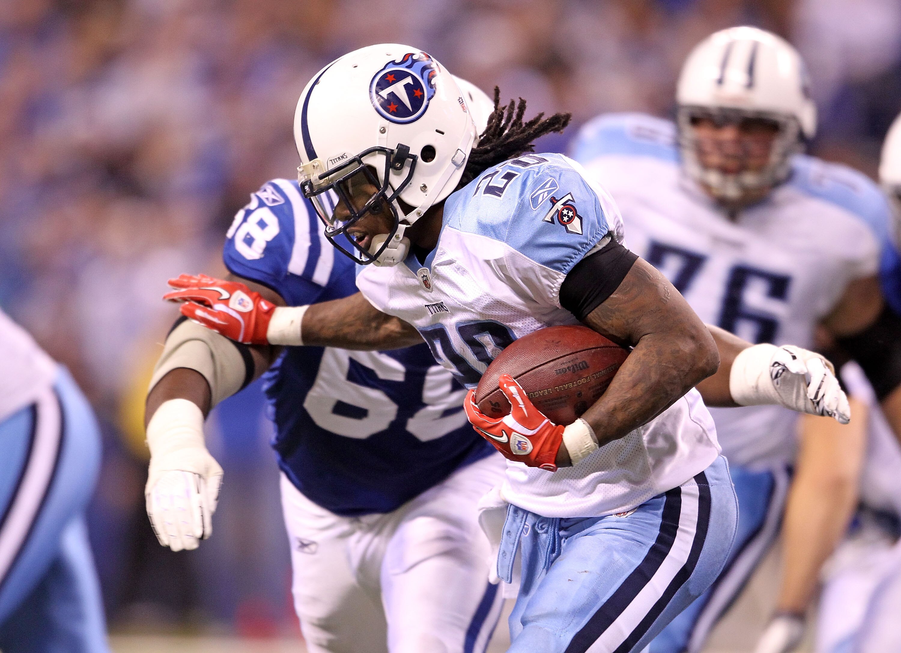 INDIANAPOLIS - JANUARY 02:  Chris Johnson #28 of the Tennessee Titans is tackled by Eric Foster #68 of the Indianapolis Colts at Lucas Oil Stadium on January 2, 2011 in Indianapolis, Indiana.  the Colts won 23-20.  (Photo by Andy Lyons/Getty Images)