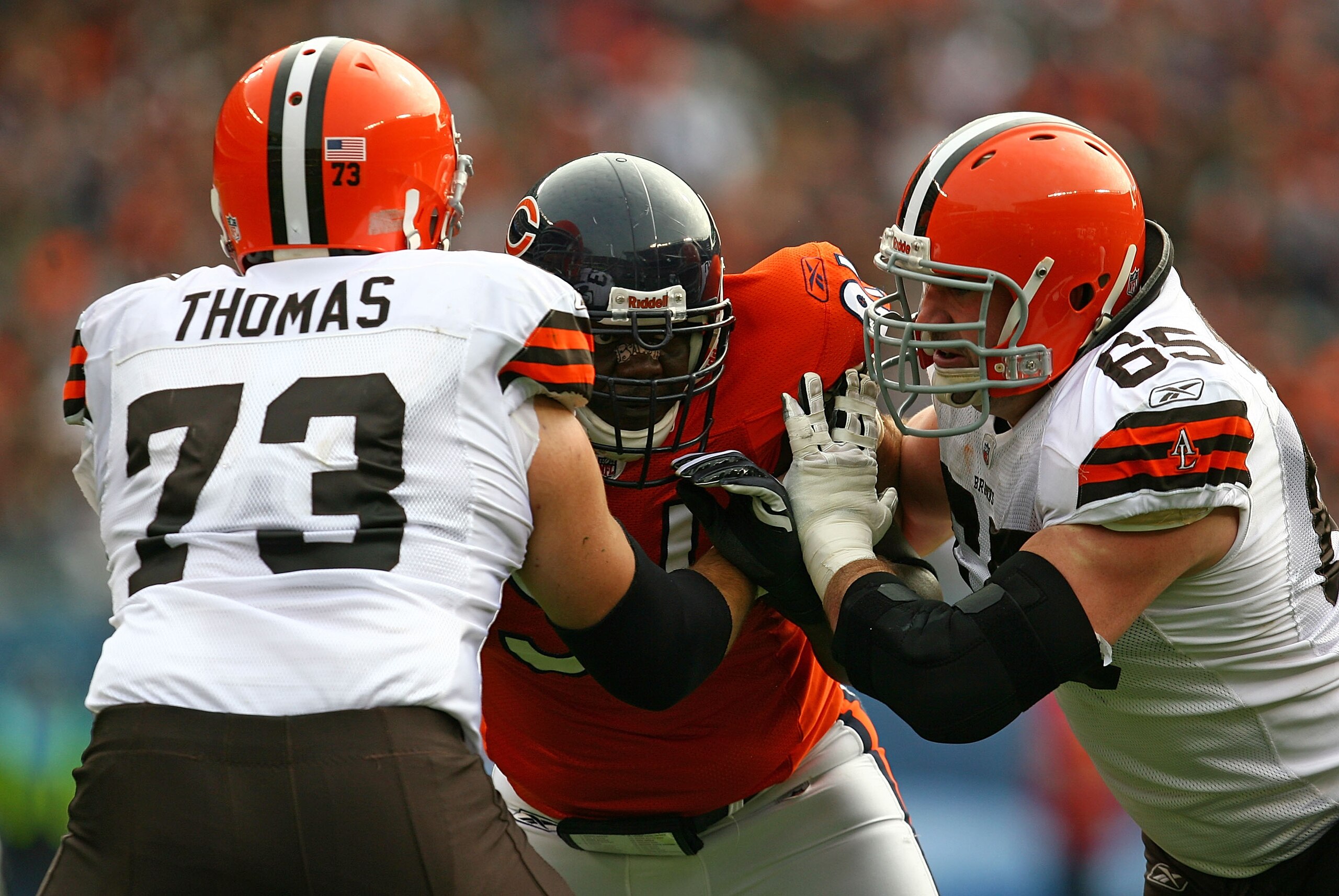 CHICAGO - NOVEMBER 01: Tommie Harris #91 of the Chicago Bears is double-teamed blocked by Joe Thomas #73 and Eric Steinbach #65 of the Cleveland Browns at Soldier Field on November 1, 2009 in Chicago, Illinois. The Bears defeated the Browns 30-6. (Photo b