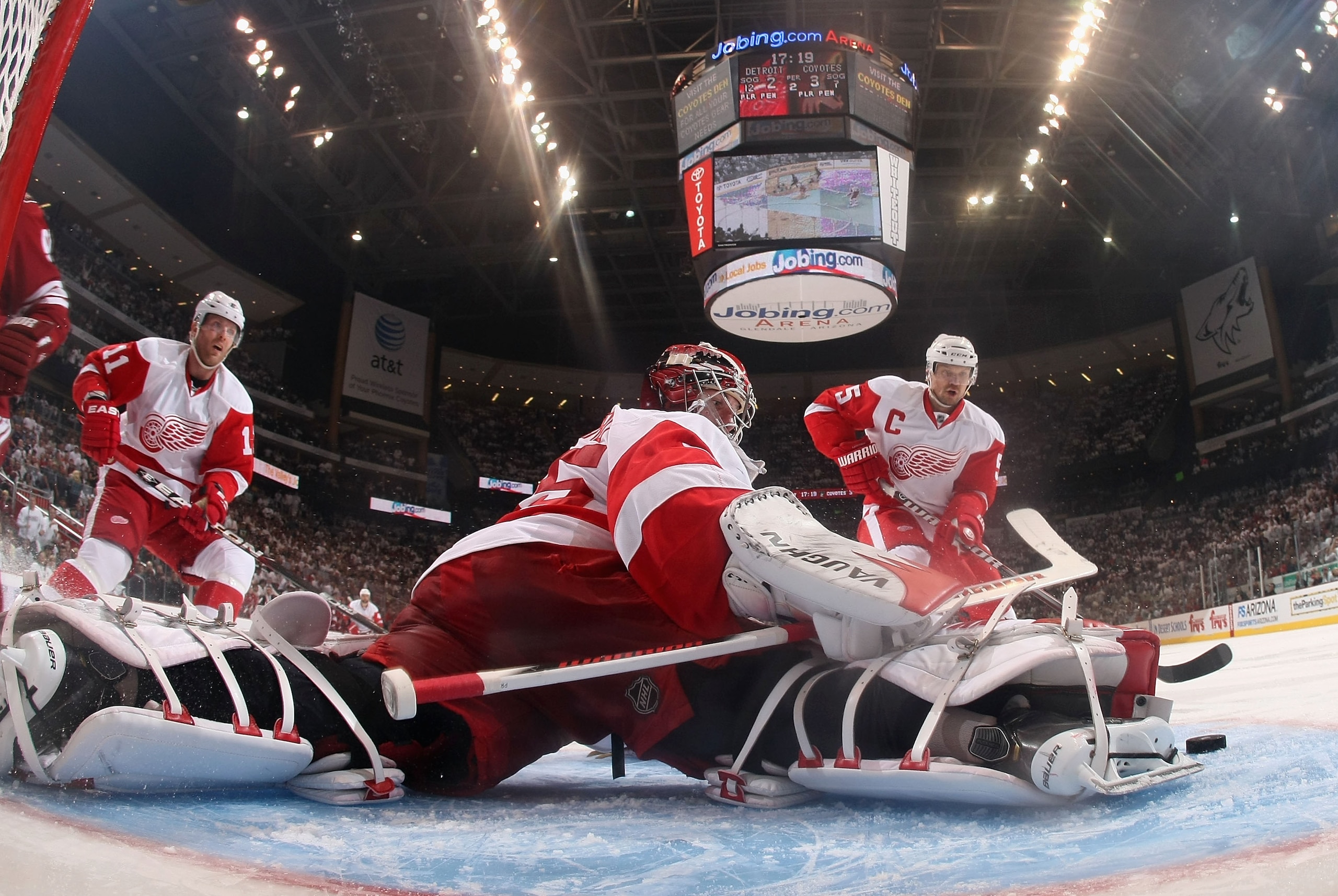 GLENDALE, AZ - APRIL 20:  Goaltender Jimmy Howard #35 of the Detroit Red Wings makes a pad save on the shot from the Phoenix Coyotes in Game Four of the Western Conference Quarterfinals during the 2011 NHL Stanley Cup Playoffs at Jobing.com Arena on April