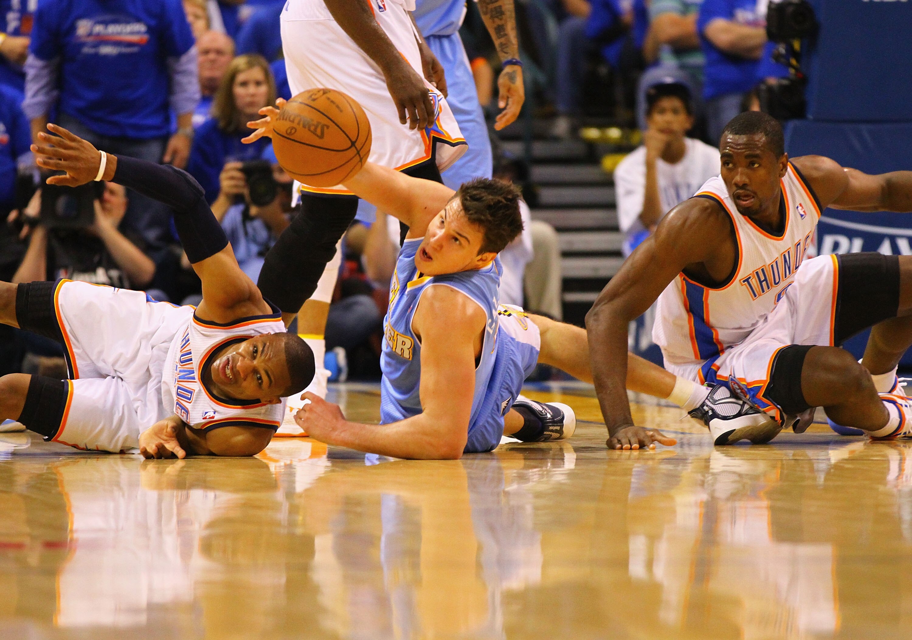 OKLAHOMA CITY, OK - APRIL 17: Russell Westbrook #0 and Serge Ibaka #9 both of the Oklahoma City Thunder look to beat Danilo Gallinari #8 of the Denver Nuggets to a loose ball in Game One of the Western Conference Quarterfinals in the 2011 NBA Playoffs on