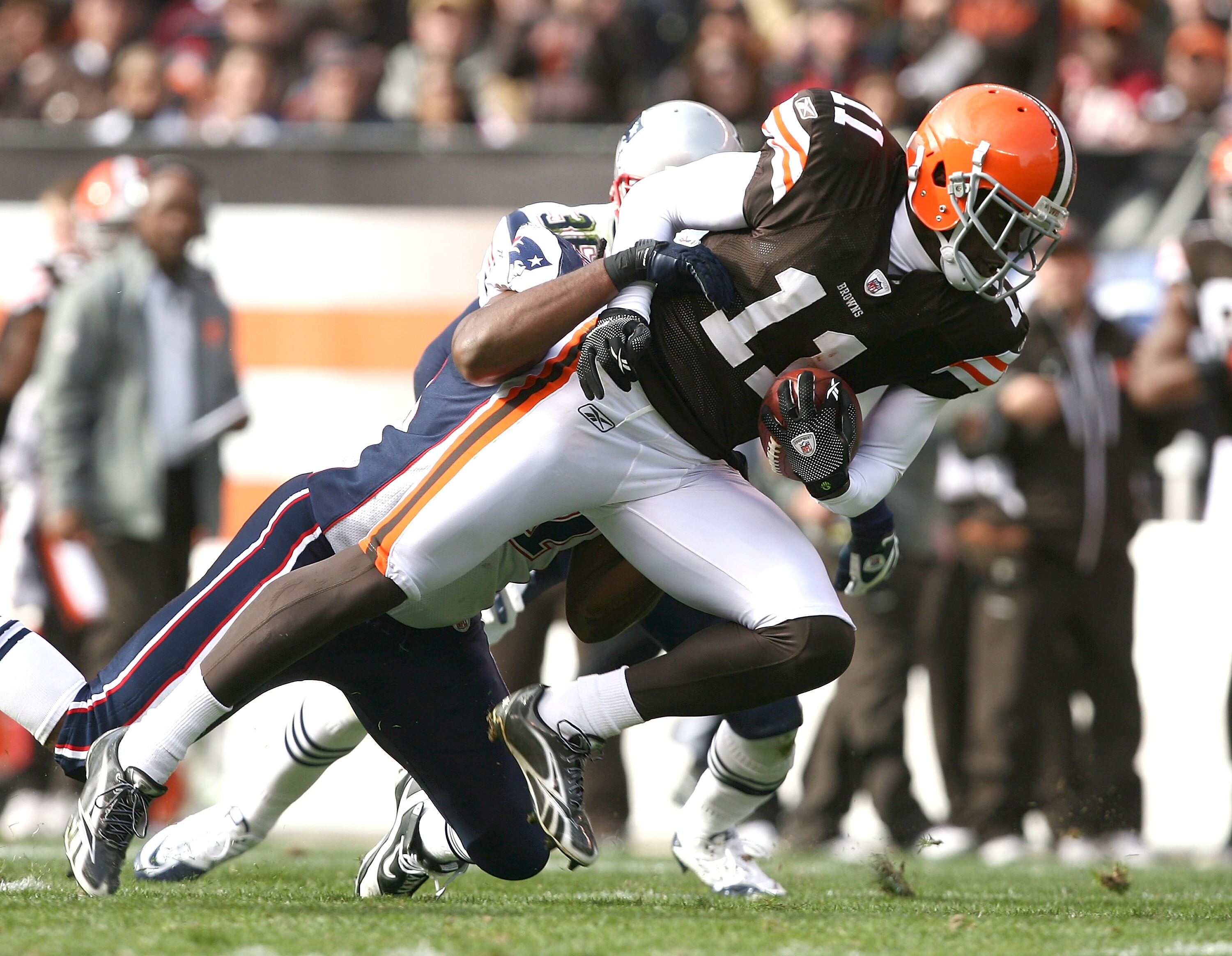 CLEVELAND - NOVEMBER 07:  Wide receiver Mohamed Massaquoi #11 of the Cleveland Browns is hit by safety James Sanders #36 of the New England Patriots at Cleveland Browns Stadium on November 7, 2010 in Cleveland, Ohio.  (Photo by Matt Sullivan/Getty Images)