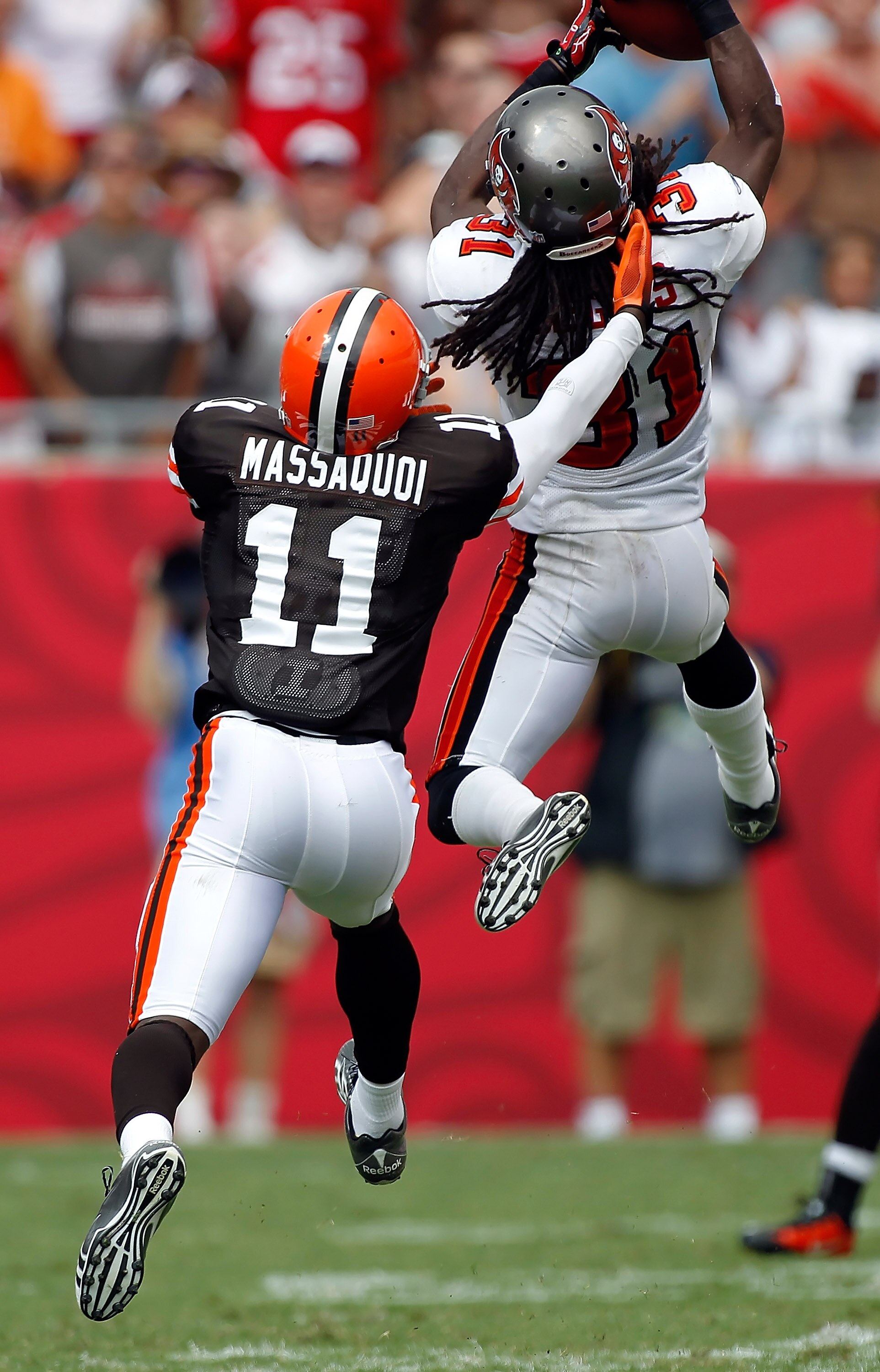 TAMPA, FL - SEPTEMBER 12:  Cornerback E.J. Biggers #31 of the Tampa Bay Buccaneers intercepts a pass intended for receiver Mohamed Massaquoi #11 of the Cleveland Browns during the NFL season opener game at Raymond James Stadium on September 12, 2010 in Ta