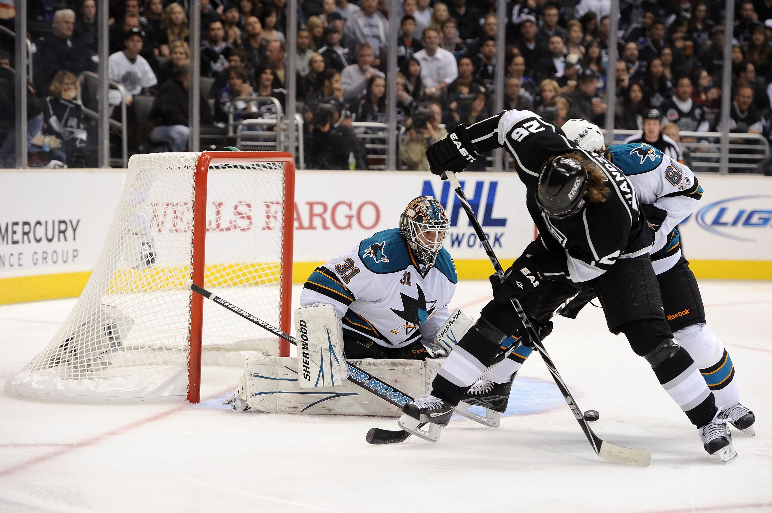 LOS ANGELES, CA - APRIL 21:  Michal Handzus #26 of the Los Angeles Kings takes a shot as Antti Niemi #31 of the San Jose Sharks looks on in game four of the Western Conference Quarterfinals during the 2011 NHL Stanley Cup Playoffs at Staples Center on Apr