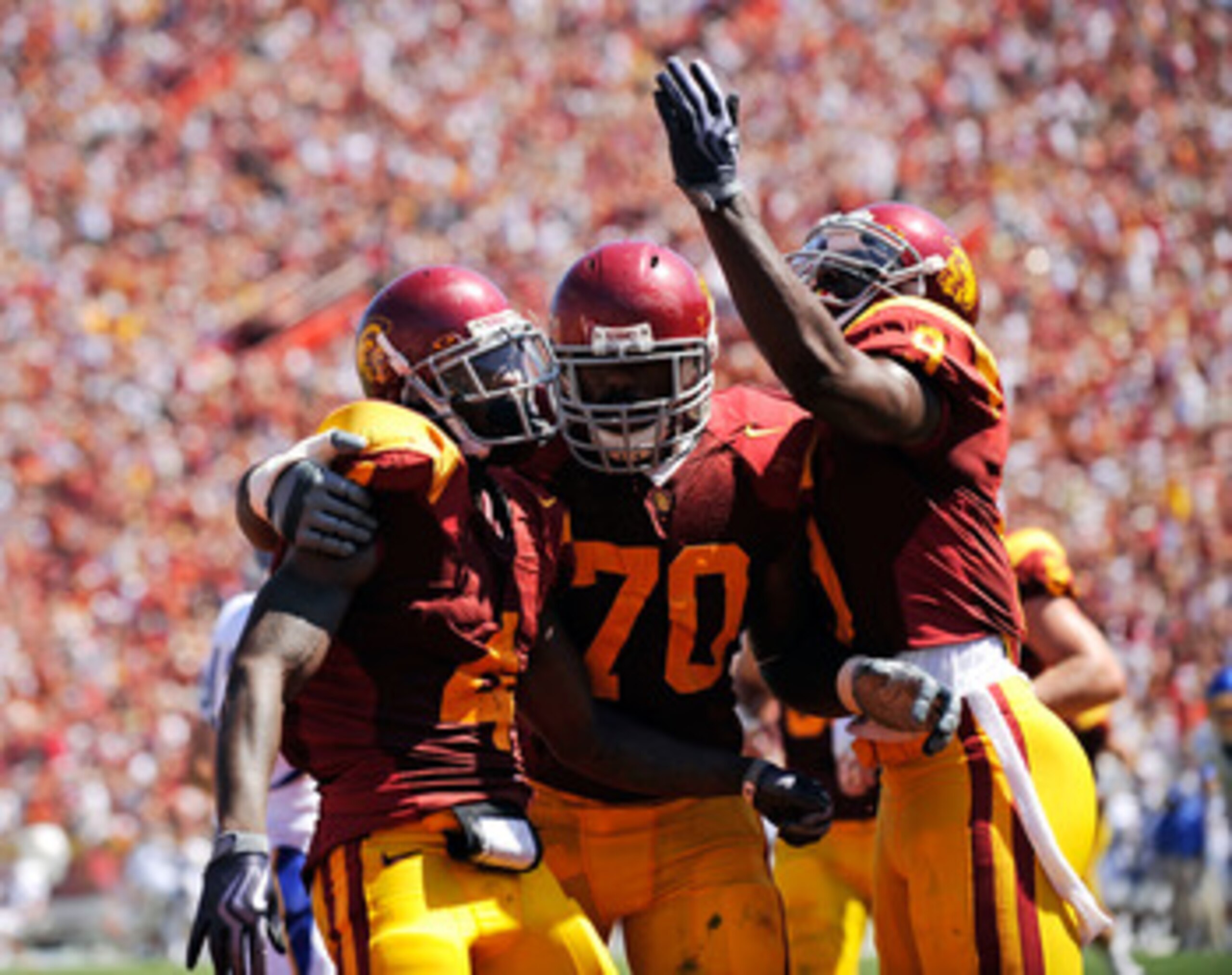 LOS ANGELES, CA - SEPTEMBER 05:  Joe McKnight #4 of the USC Trojans celebrates his touchdown with Tyron Smith #70 and David Ausberry #9 during the second quarter against the San Jose State Spartans at Los Angeles Memorial Coliseum on September 5, 2009 in 