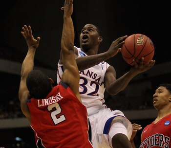 SAN ANTONIO, TX - MARCH 25:  Josh Selby #32 of the Kansas Jayhawks goes to the basket against Cedrick Lindsay #2 of the Richmond Spiders during the southwest regional of the 2011 NCAA men's basketball tournament at the Alamodome on March 25, 2011 in San A