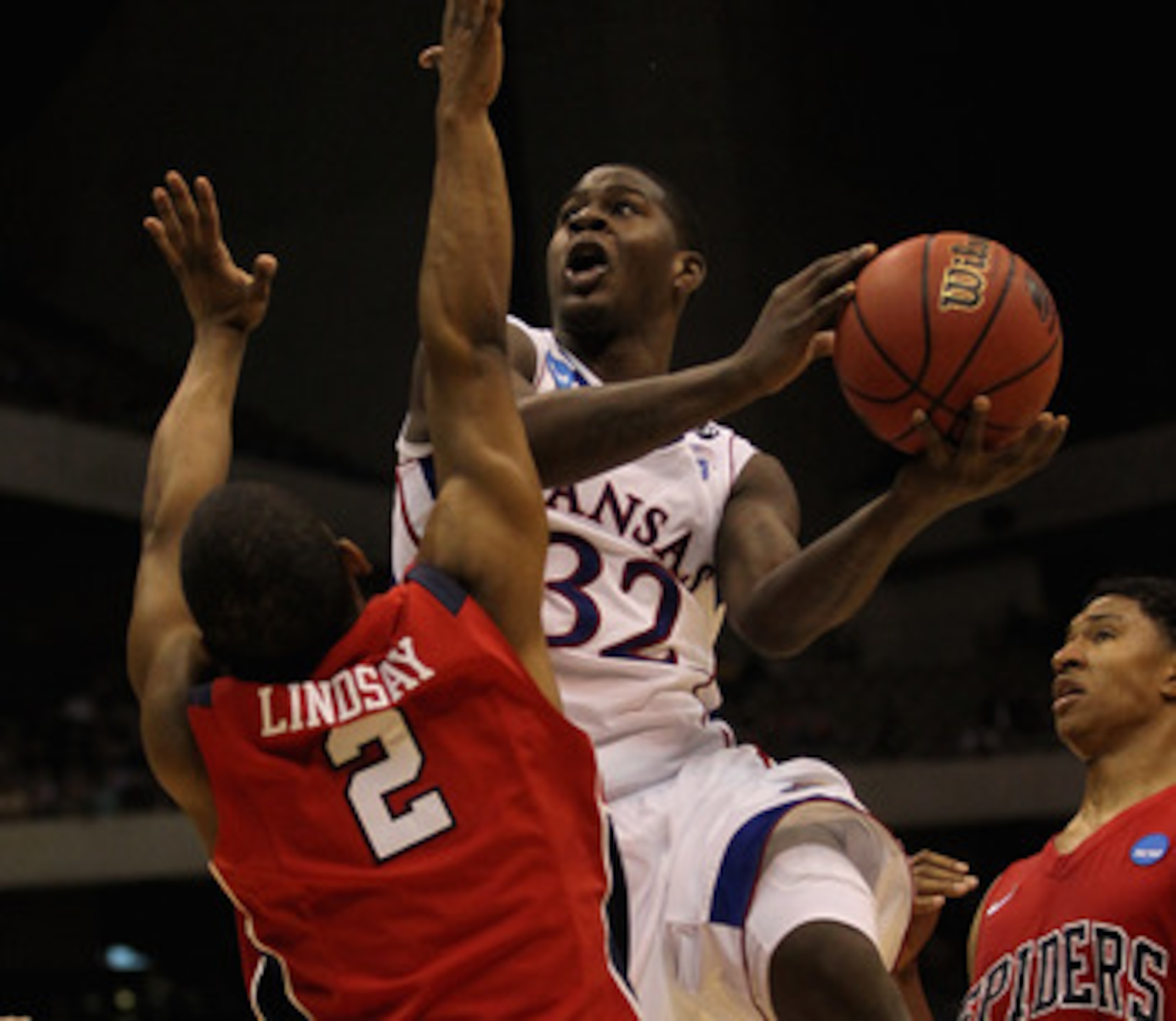 SAN ANTONIO, TX - MARCH 25: Josh Selby #32 of the Kansas Jayhawks goes to the basket against Cedrick Lindsay #2 of the Richmond Spiders during the southwest regional of the 2011 NCAA men's basketball tournament at the Alamodome on March 25, 2011 in San A SAN ANTONIO, TX - MARCH 25: Josh Selby #32 of the Kansas Jayhawks goes to the basket against Cedrick Lindsay #2 of the Richmond Spiders during the southwest regional of the 2011 NCAA men's basketball tournament at the Alamodome on March 25, 2011 in San A
