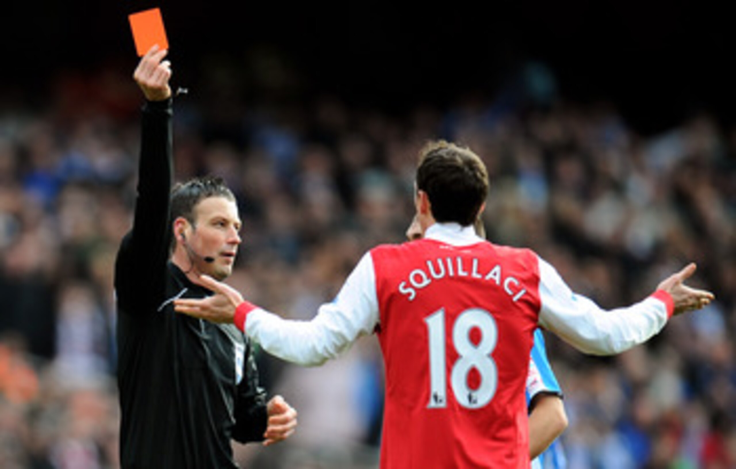 LONDON, ENGLAND - JANUARY 30:  Sebastien Squillaci #30 of Arsenal is shown a straight red card by Referee Mark Clattenburg after his foul on Jack Hunt of Huddersfield during the FA Cup sponsored by E.ON fourth round match between Arsenal and Huddersfield