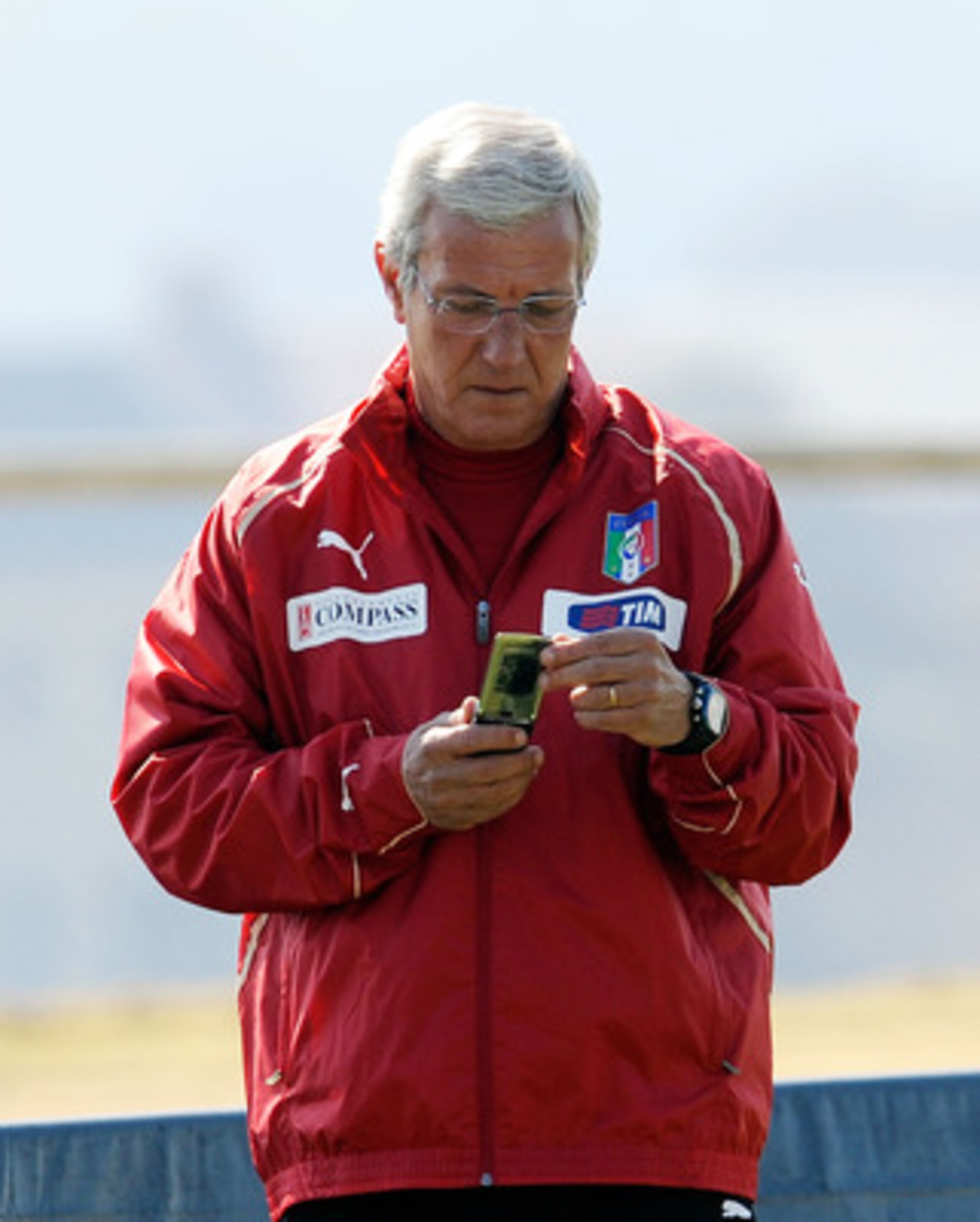 CENTURION, SOUTH AFRICA - JUNE 22:  Head coach Marcello Lippi looks at his phone during an Italy training session ahead of their 2010 FIFA World Cup Group Stage Round 3 Group F match against Slovakia  on June 22, 2010 in Centurion, South Africa.  (Photo b