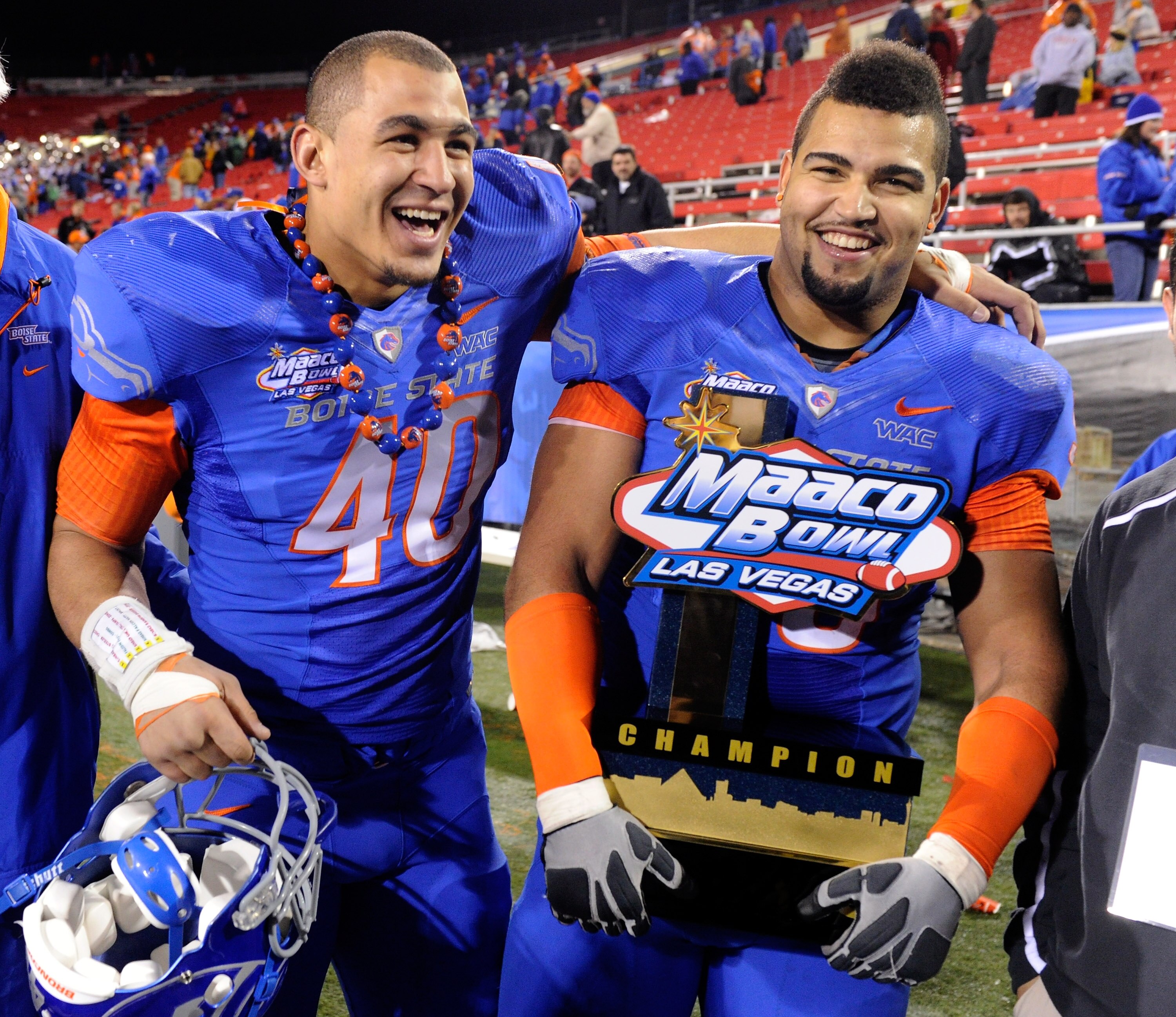 LAS VEGAS, NV - DECEMBER 22:  Tyrone Crawford #40 and Billy Winn #90 of the Boise State Broncos celebrate with a trophy after the team's 26-3 victory over the Utah Utes in the MAACO Bowl Las Vegas at Sam Boyd Stadium December 22, 2010 in Las Vegas, Nevada