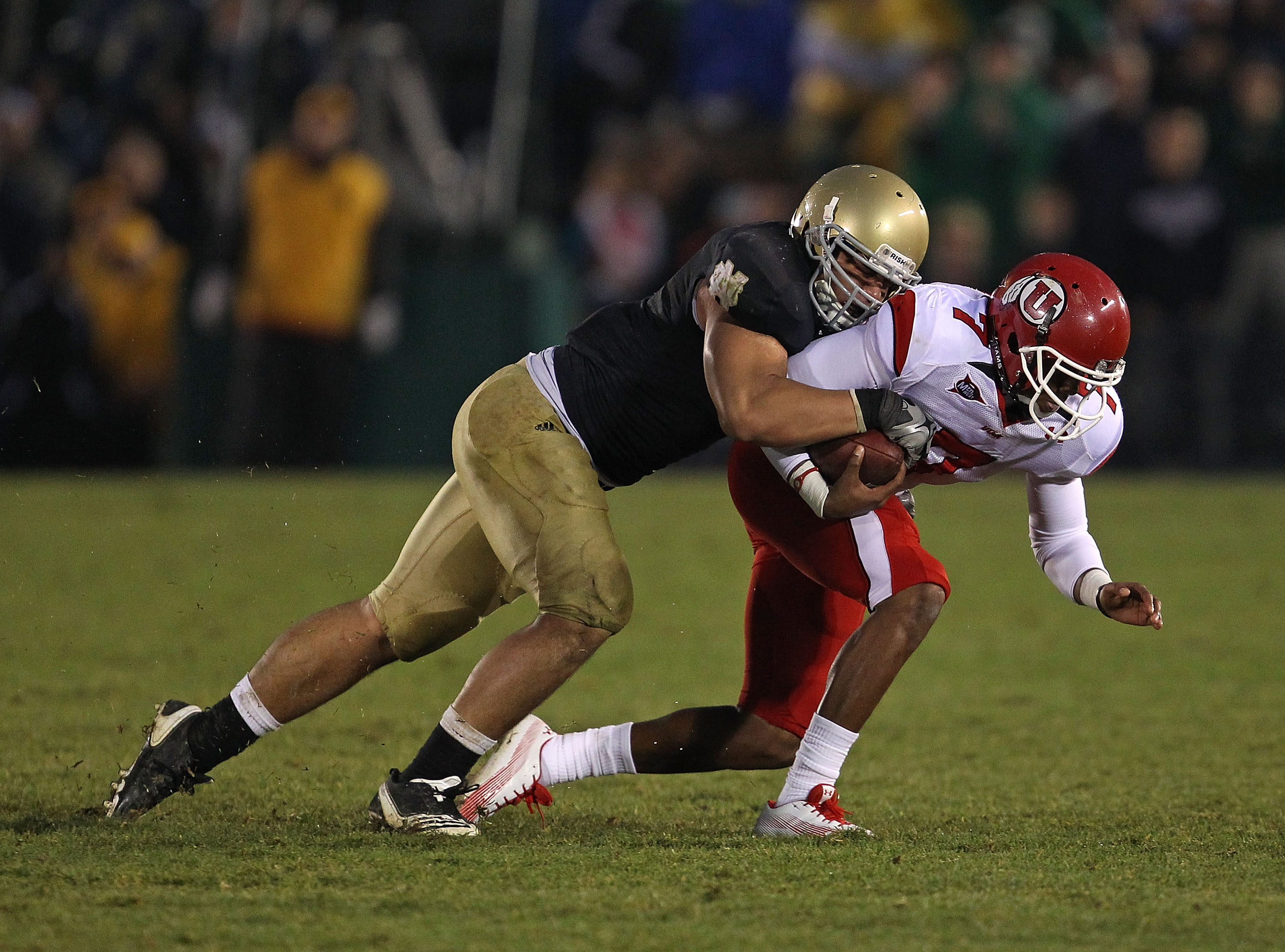 SOUTH BEND, IN - NOVEMBER 13: Manti Te'o #5 of the Notre Dame Fighting Irish brings down Terrance Cain #7 of the Utah Utes at Notre Dame Stadium on November 13, 2010 in South Bend, Indiana. Notre Dame defeated Utah 28-3. (Photo by Jonathan Daniel/Getty Im