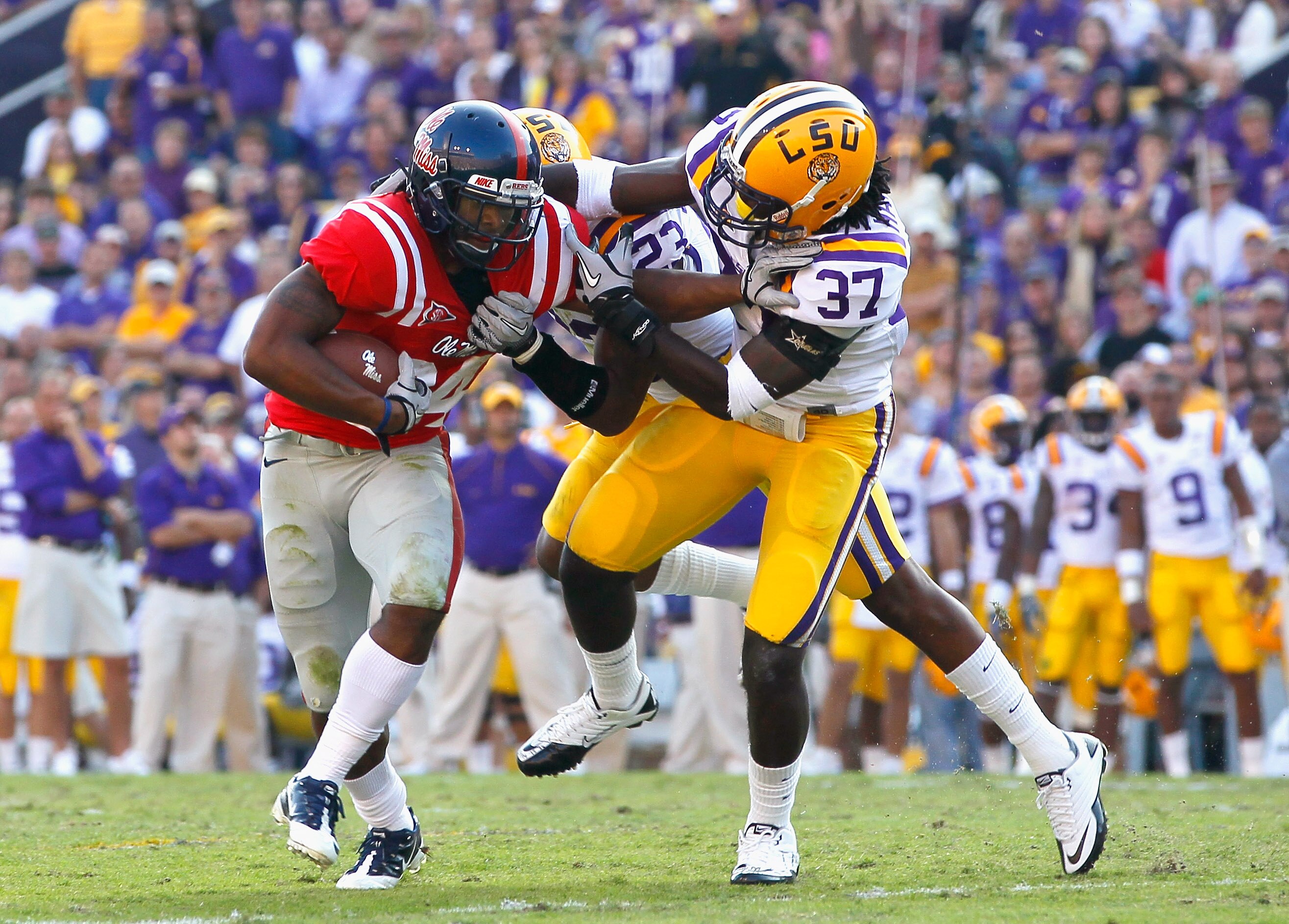BATON ROUGE, LA - NOVEMBER 20:  Stefoin Francois #23 and Karnell Hatcher #37 of the Louisiana State University Tigers tackle Brandon Bolden #34 of the Ole Miss Rebels at Tiger Stadium on November 20, 2010 in Baton Rouge, Louisiana.  (Photo by Kevin C. Cox