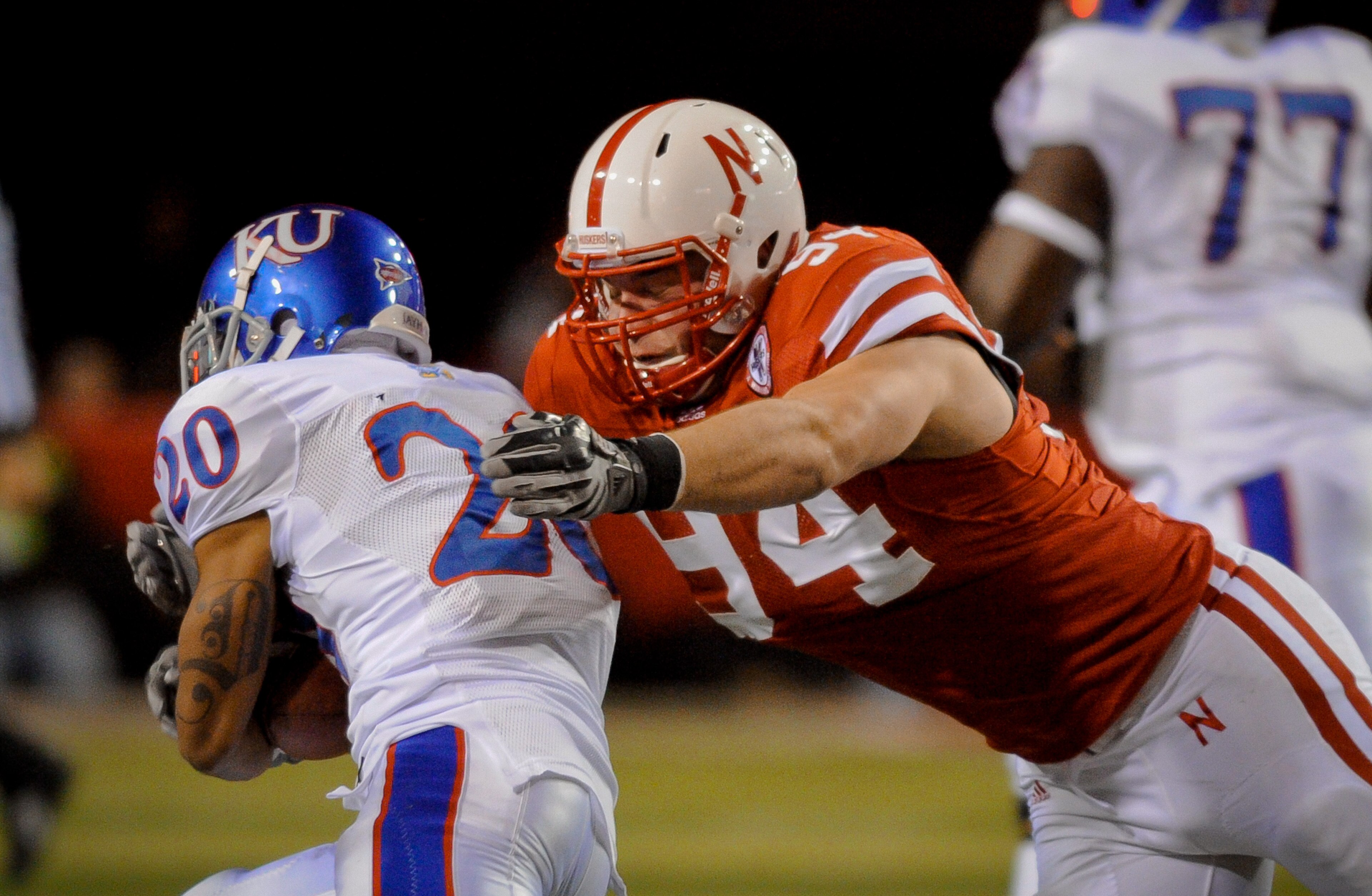 LINCOLN, NE - NOVEMBER 13: Jared Crick #94 of the Nebraska Cornhuskers runs down D.J. Beshears #20 of the Kansas Jayhawks during first half action of their game at Memorial Stadium on November 13, 2010 in Lincoln, Nebraska.  (Photo by Eric Francis/Getty I