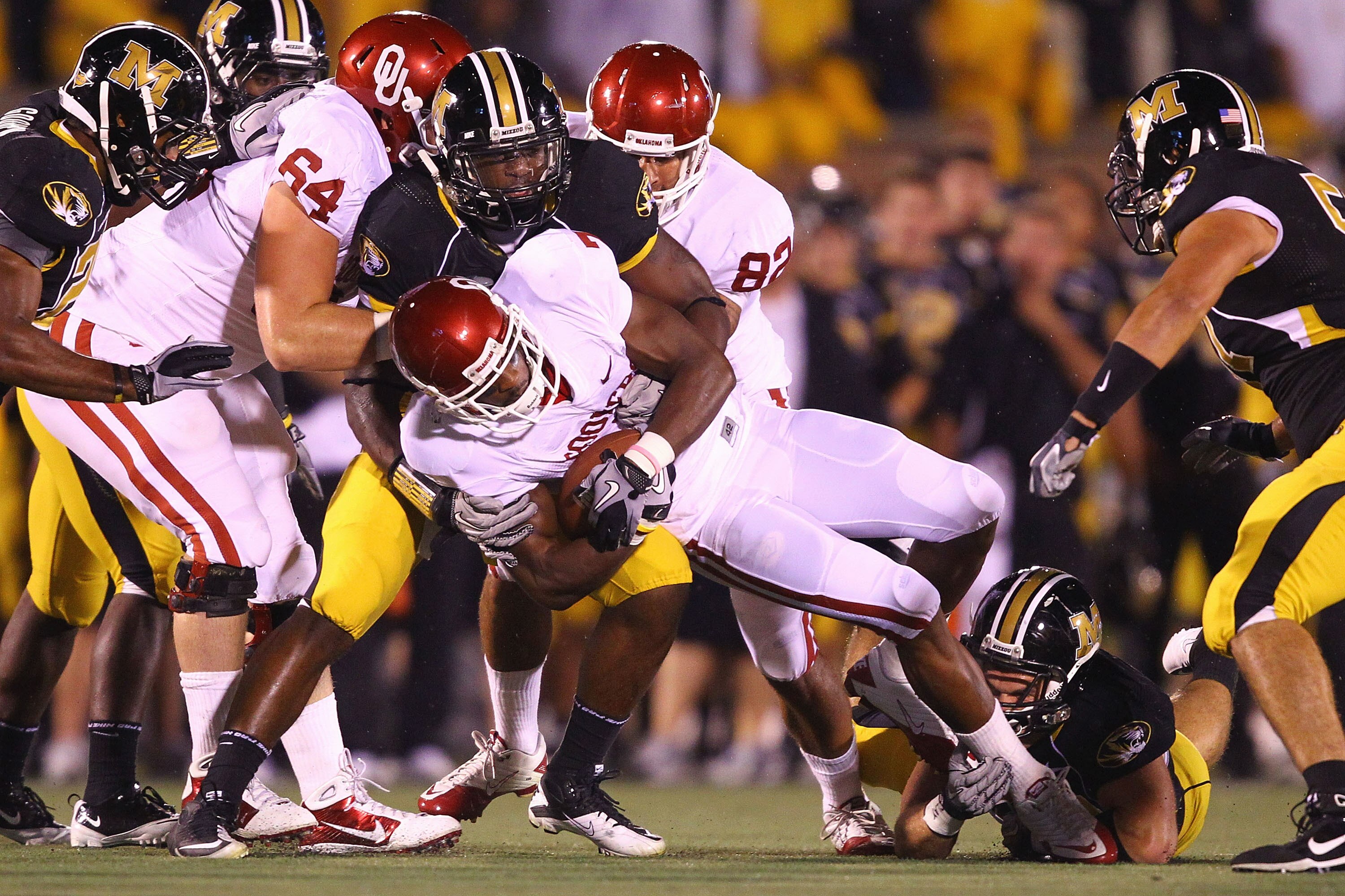 COLUMBIA, MO - OCTOBER 23: DeMarco Murray #7 of the Oklahoma Sooners is tackled by Jacquies Smith #3 of the Missouri Tigers at Faurot Field/Memorial Stadium on October 23, 2010 in Columbia, Missouri.  (Photo by Dilip Vishwanat/Getty Images)