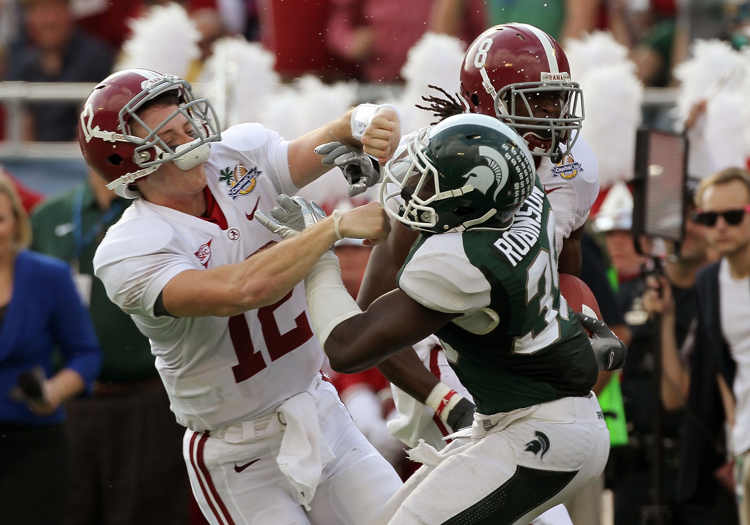 ORLANDO, FL - JANUARY 01: Greg McElroy #12 of the Alabama Crimson Tide blocks Trenton Robinson #39 of the Michigan State Spartans on a touchdown run during the Capitol One Bowl at the Florida Citrus Bowl on January 1, 2011 in Orlando, Florida. (Photo b ORLANDO, FL - JANUARY 01: Greg McElroy #12 of the Alabama Crimson Tide blocks Trenton Robinson #39 of the Michigan State Spartans on a touchdown run during the Capitol One Bowl at the Florida Citrus Bowl on January 1, 2011 in Orlando, Florida. (Photo b
