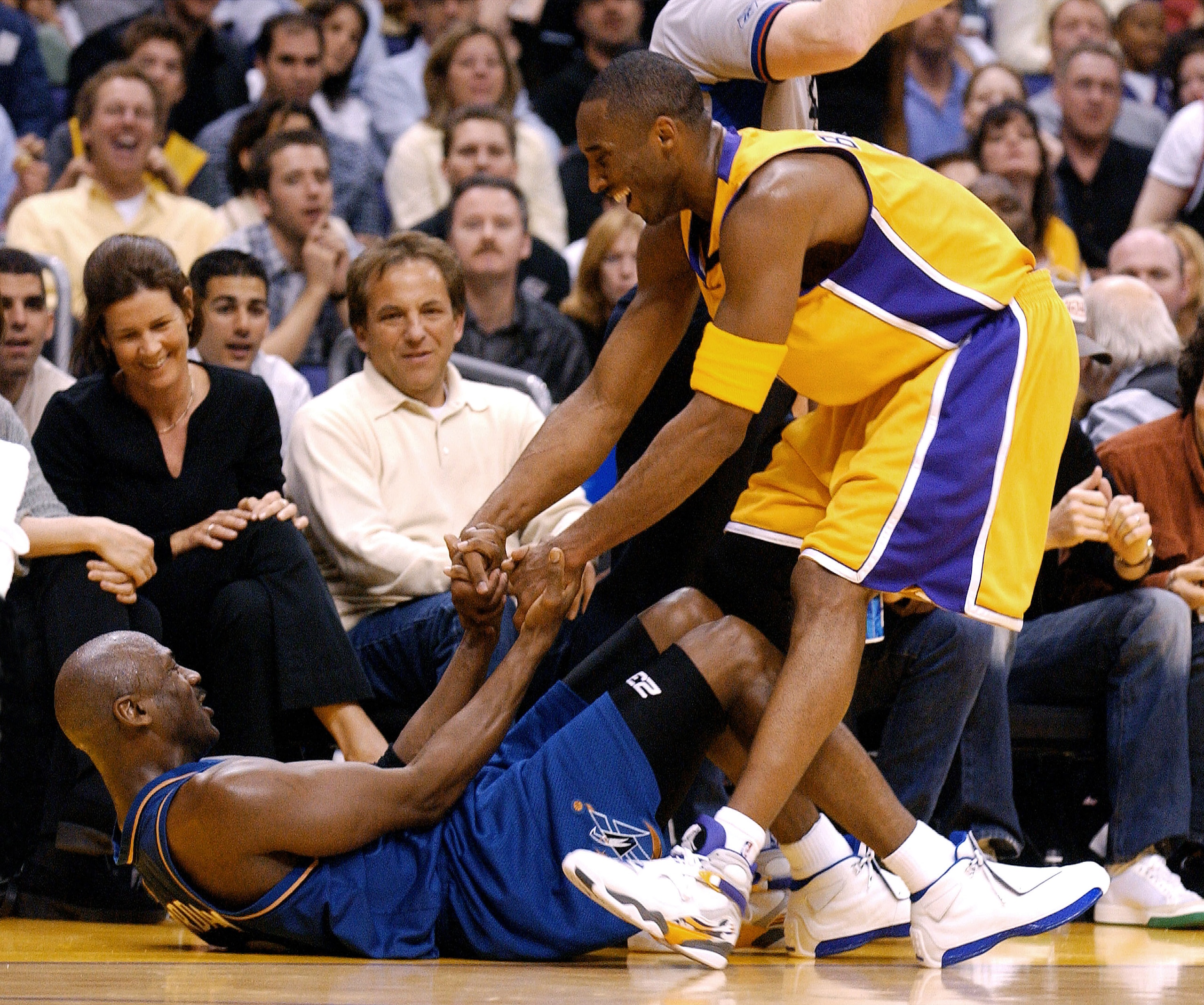 LOS ANGELES - MARCH 28:  Kobe Bryant #8 of the Los Angeles Lakers helps up Michael Jordan#23 of the Washington Wizards during the game between the Washington Wizards and the Los Angeles Lakers on March 28, 2003 at the Staples Center in Los Angeles, Califo