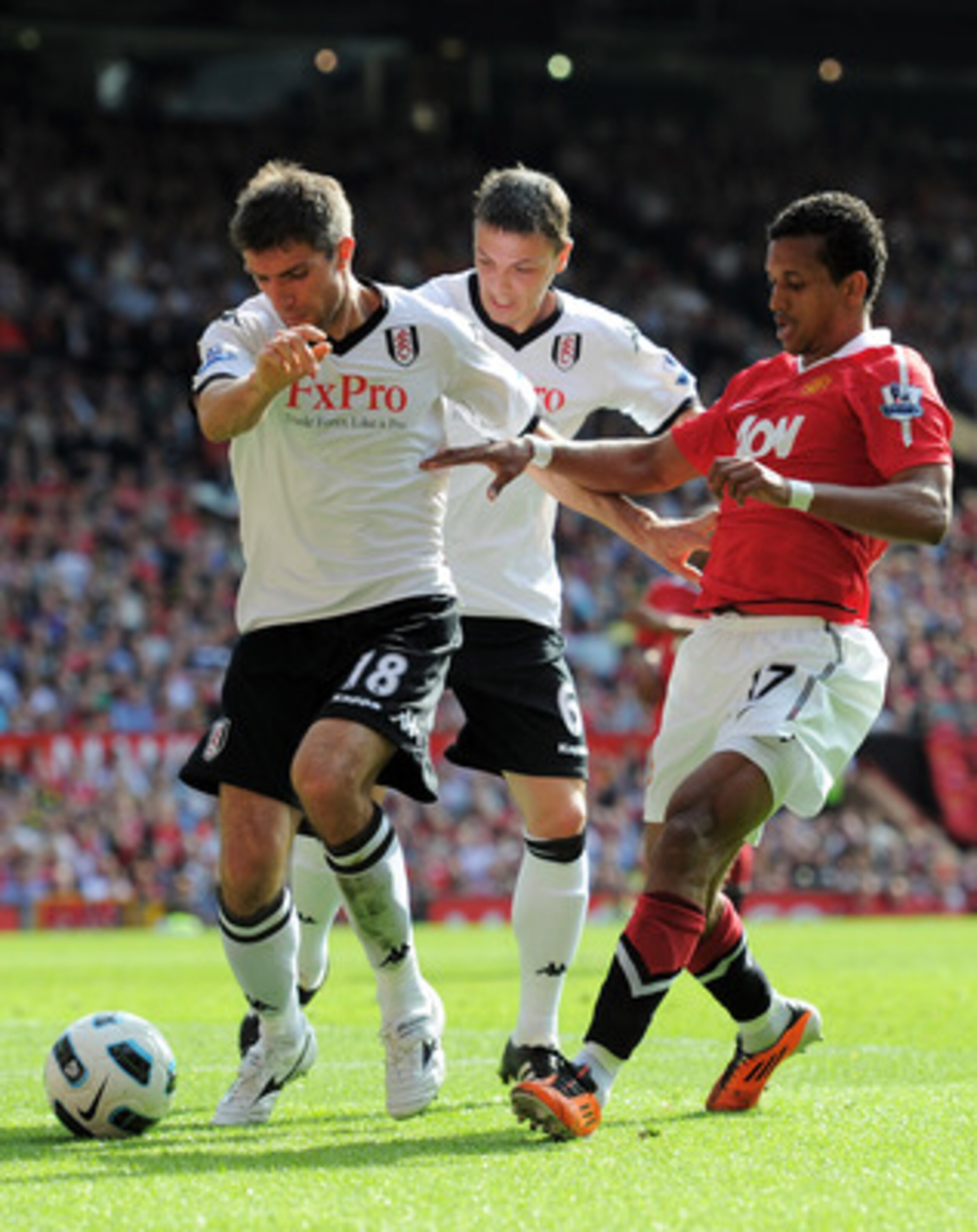 MANCHESTER, ENGLAND - APRIL 09:  Nani of Manchester United is shut out by Aaron Hughes (L) and Chris Baird of Fulham during the Barclays Premier League match between Manchester United and Fulham at Old Trafford on April 9, 2011 in Manchester, England.  (P