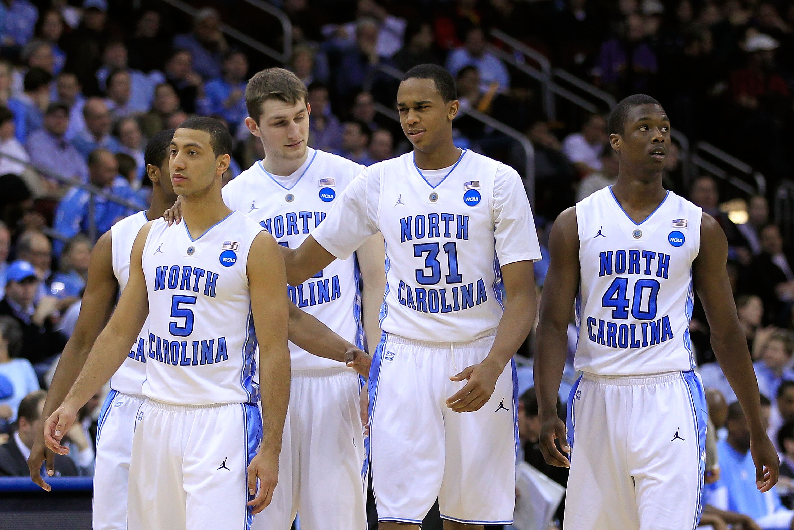 NEWARK, NJ - MARCH 25:  Dexter Strickland #1, Kendall Marshall #5, John Henson #31 and Harrison Barnes #40  of the North Carolina Tar Heels walk on the court after a play against the Marquette Golden Eagles during the east regional semifinal of the 2011 N