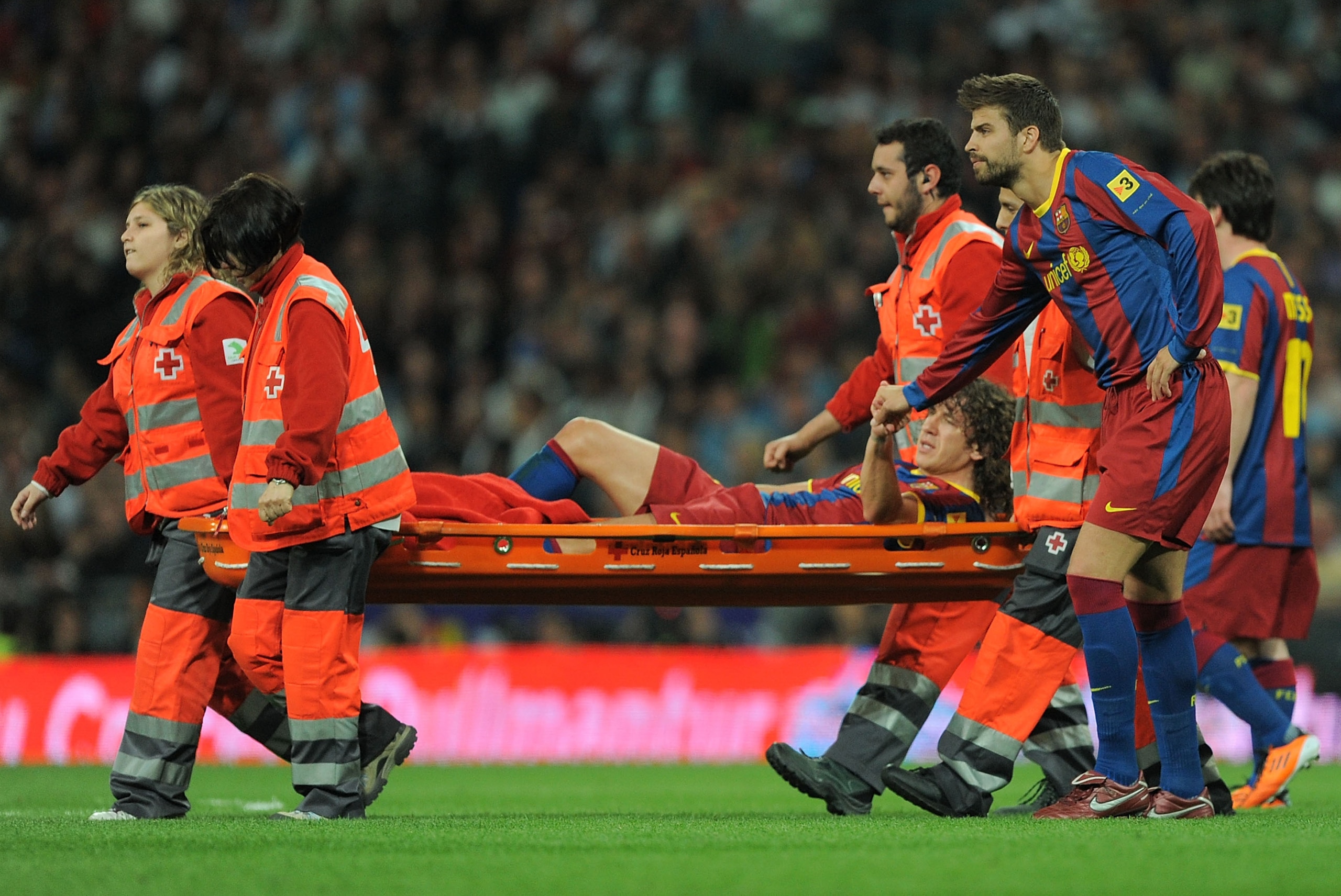 MADRID, SPAIN - APRIL 16:  Gerard Pîque of Barcelona consoles Carles Puyol after he was injured  during the La Liga match between Real Madrid and Barcelona at Estadio Santiago Bernabeu on April 16, 2011 in Madrid, Spain.  (Photo by Denis Doyle/Getty Image