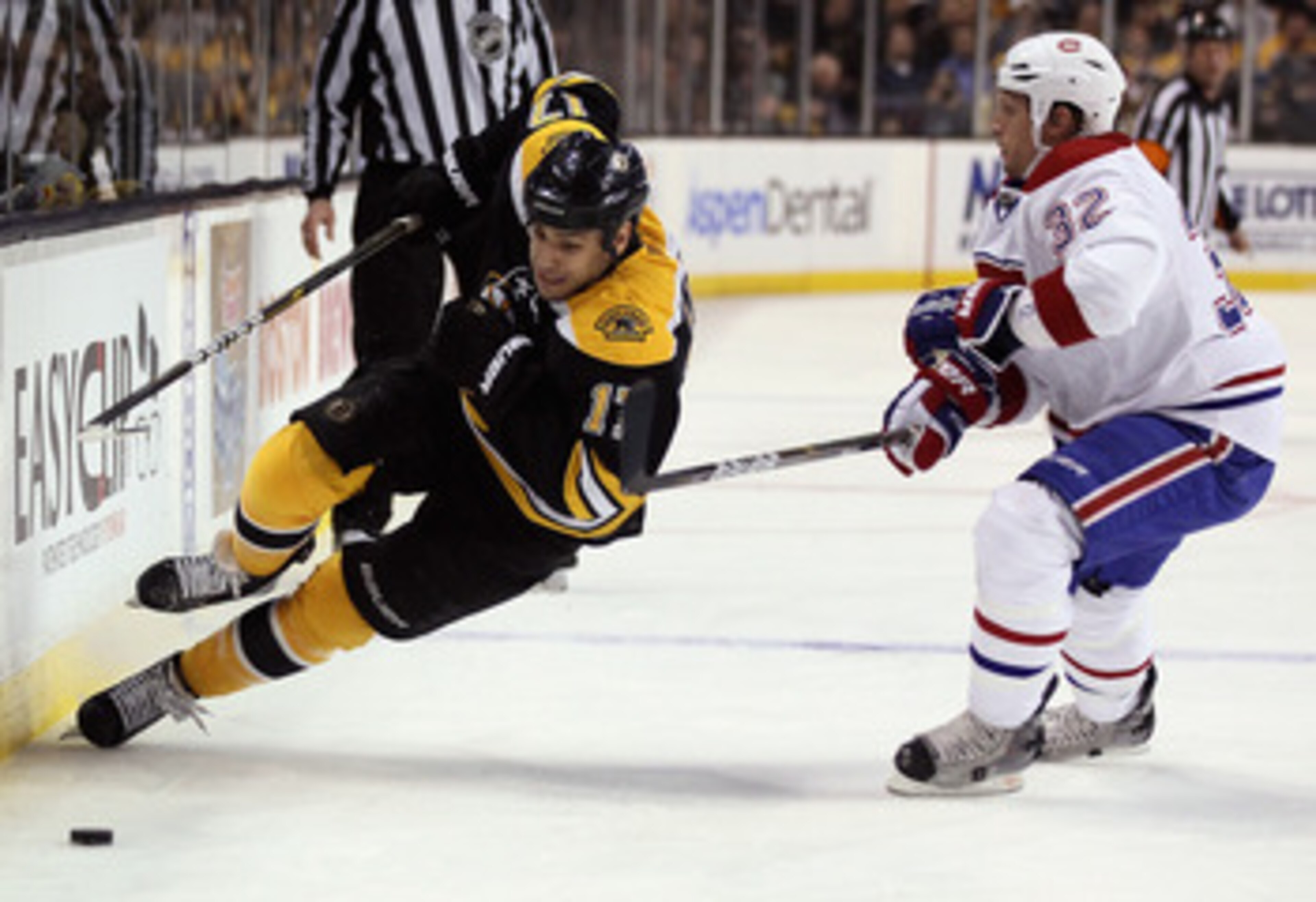 BOSTON, MA - APRIL 14: Milan Lucic #17 of the Boston Bruins is hit by Travis Moen #32 of the Montreal Canadiens in Game One of the Eastern Conference Quarterfinals during the 2011 NHL Stanley Cup Playoffs at TD Garden on April 14, 2011 in Boston, Massach BOSTON, MA - APRIL 14: Milan Lucic #17 of the Boston Bruins is hit by Travis Moen #32 of the Montreal Canadiens in Game One of the Eastern Conference Quarterfinals during the 2011 NHL Stanley Cup Playoffs at TD Garden on April 14, 2011 in Boston, Massach