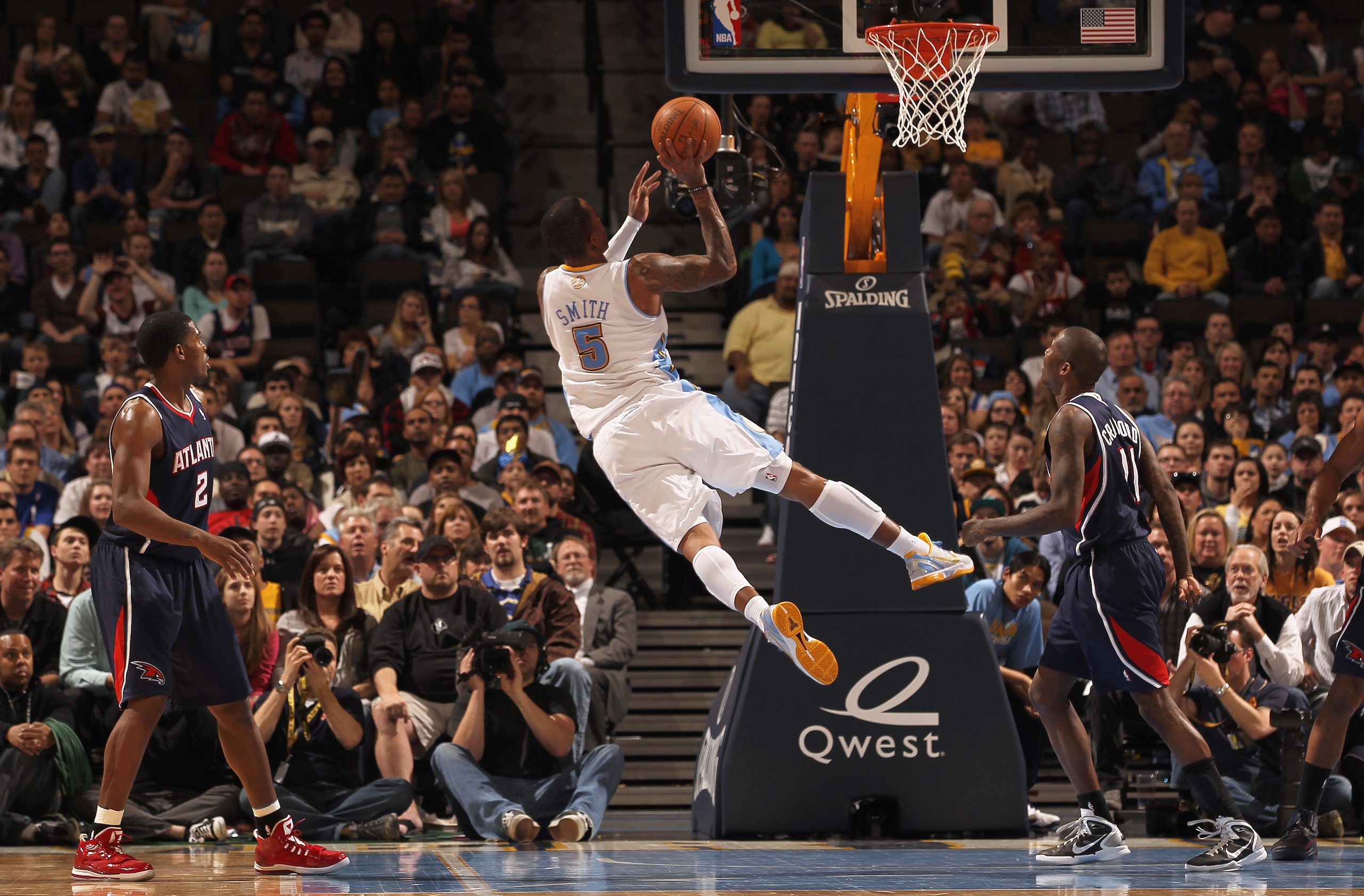 DENVER, CO - FEBRUARY 28:  J.R. Smith #5 of the Denver Nuggets puts up a shot between Joe Johnson #2 and Jamal Crawford #11 of the Atlanta Hawks during NBA action at the Pepsi Center on February 28, 2011 in Denver, Colorado. The Nuggets deafeated the Hawk