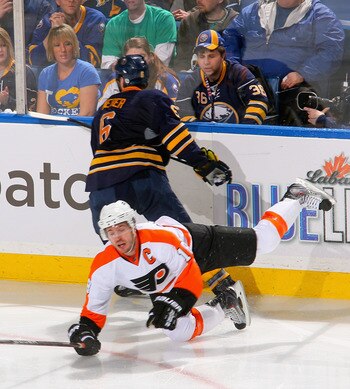 BUFFALO, NY - APRIL 20: Mike Richards #18 of the Philadelphia Flyers falls to the ice after being hit by Mike Weber #6 of the Buffalo Sabres  in Game Four of the Eastern Conference Quarterfinals during the 2011 NHL Stanley Cup Playoffs at HSBC Arena at HS