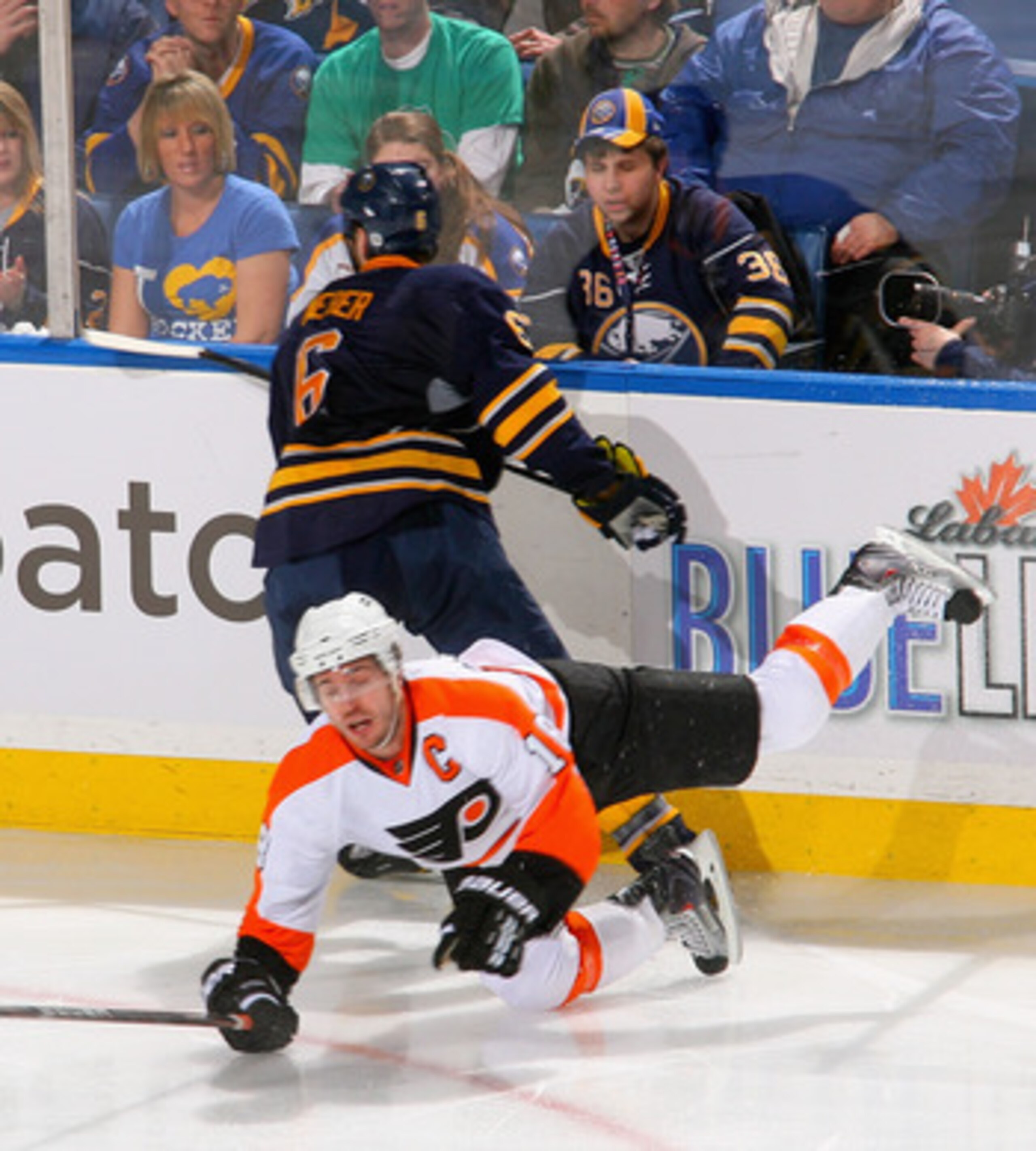 BUFFALO, NY - APRIL 20: Mike Richards #18 of the Philadelphia Flyers falls to the ice after being hit by Mike Weber #6 of the Buffalo Sabres  in Game Four of the Eastern Conference Quarterfinals during the 2011 NHL Stanley Cup Playoffs at HSBC Arena at HS