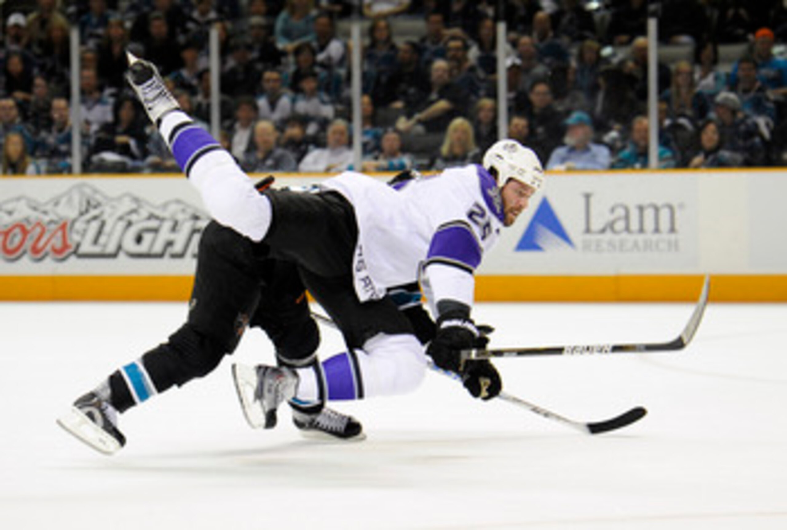 SAN JOSE, CA - APRIL 16: Dustin Penner #25 of the Los Angeles Kings is tripped up by Dan Boyle #22 of the San Jose Sharks in Game Two of the Western Conference Quarterfinals  during the 2011 NHL Stanley Cup Playoffs at the HP Pavilion on April 16, 2011 in