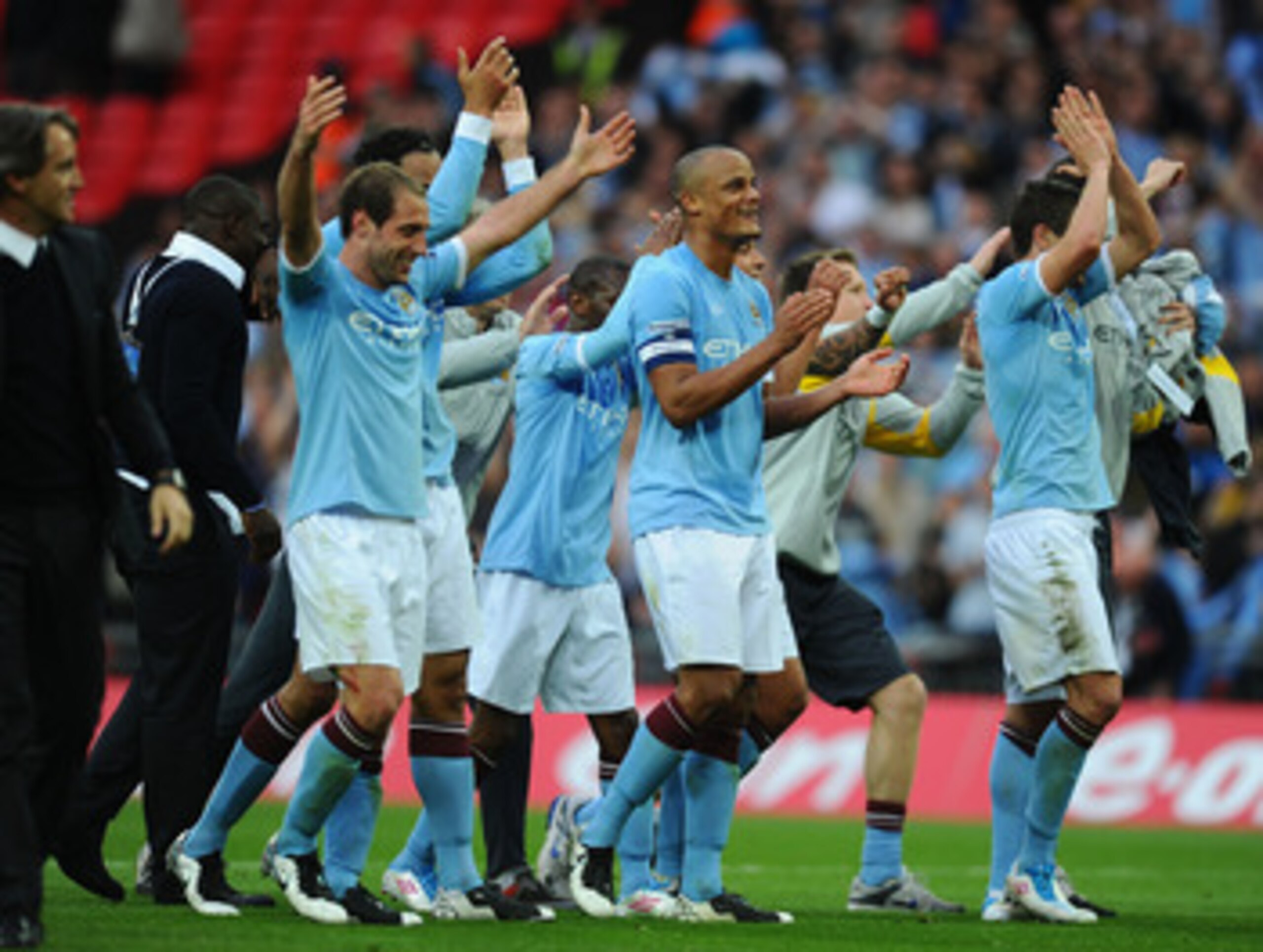 LONDON, ENGLAND - APRIL 16: Vincent Kompany of Manchester City celebrates with his team mates at the final whistle during the FA Cup sponsored by E.ON semi final match between Manchester City and Manchester United at Wembley Stadium on April 16, 2011 in L