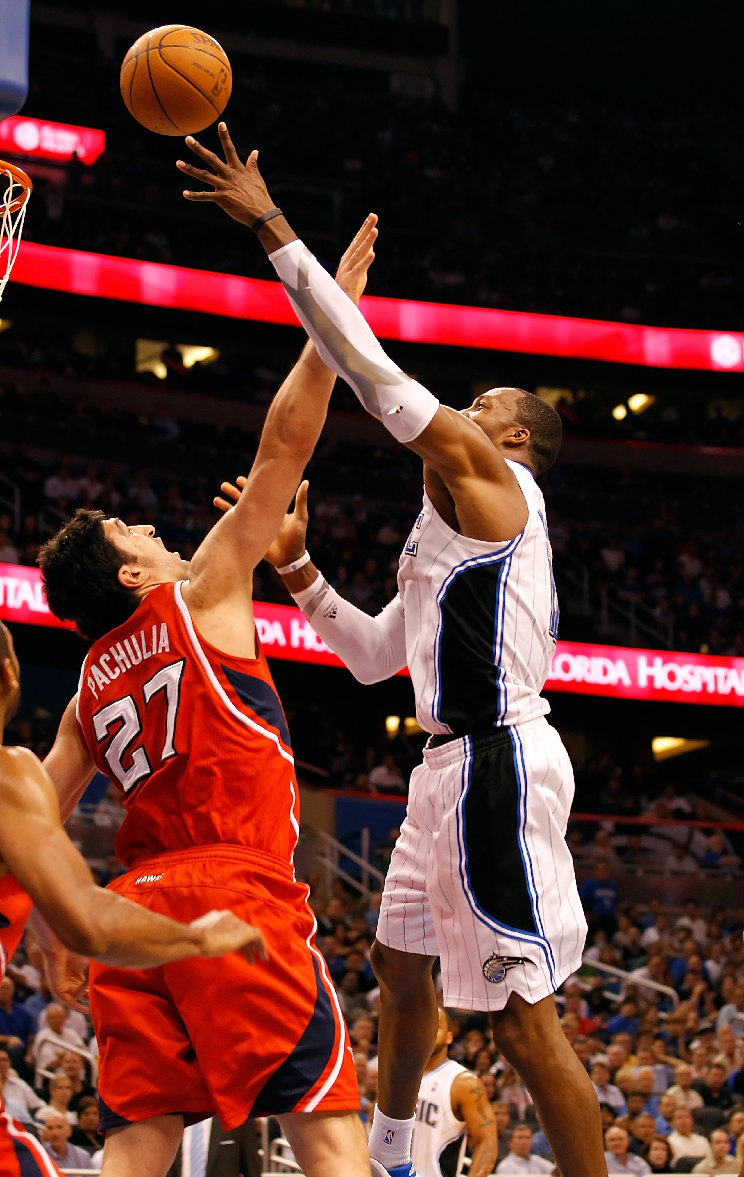 ORLANDO, FL - APRIL 19:  Dwight Howard #12 of the Orlando Magic shoots over Zaza Pachulia #27 of the Atlanta Hawks during Game Two of the Eastern Conference Quarterfinals of the 2011 NBA Playoffs on April 19, 2011 at the Amway Arena in Orlando, Florida.  