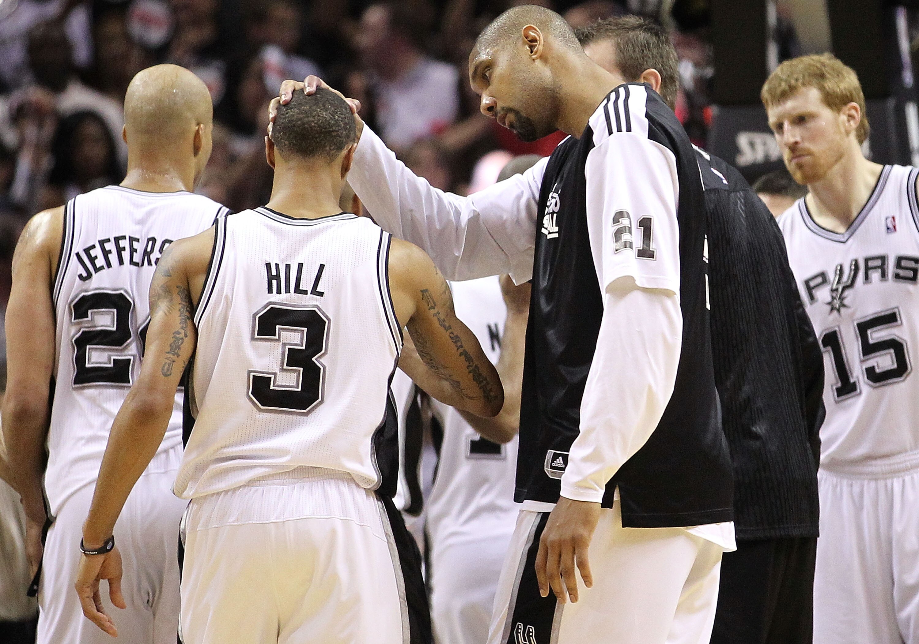 SAN ANTONIO, TX - APRIL 20:  Tim Duncan #21 pats the head of George Hill #3 of the San Antonio Spurs after a win against the Memphis Grizzlies in Game Two of the Western Conference Quarterfinals in the 2011 NBA Playoffs on April 20, 2011 at AT&T Center in