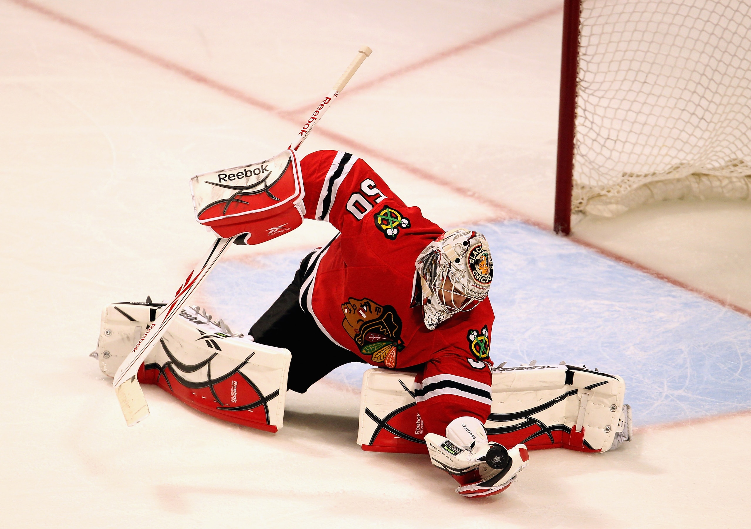 CHICAGO, IL - APRIL 19: Corey Crawford #50 of the Chicago Blackhawks makes a save against the Vancouver Canucks in Game Four of the Western Conference Quarterfinals during the 2011 NHL Stanley Cup Playoffs at the United Center on April 19, 2011 in Chicago