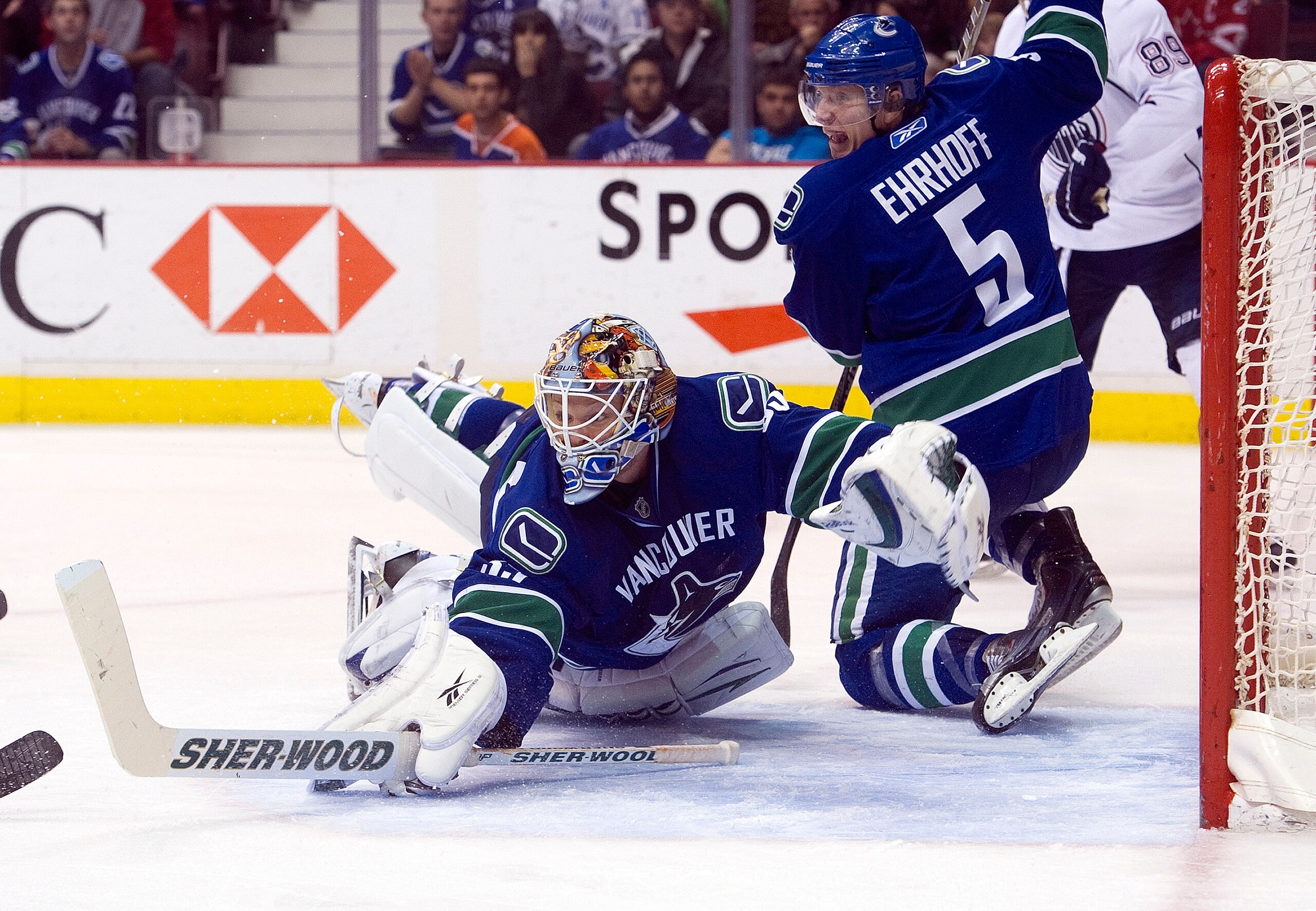 VANCOUVER, CANADA - DECEMBER 26: Goalie Cory Schneider #35 of the Vancouver Canucks dives back to his net to make a save against the Edmonton Oilers while Christian Ehrhoff #5 looks on during the third period in NHL action on December 26, 2010 at Rogers A