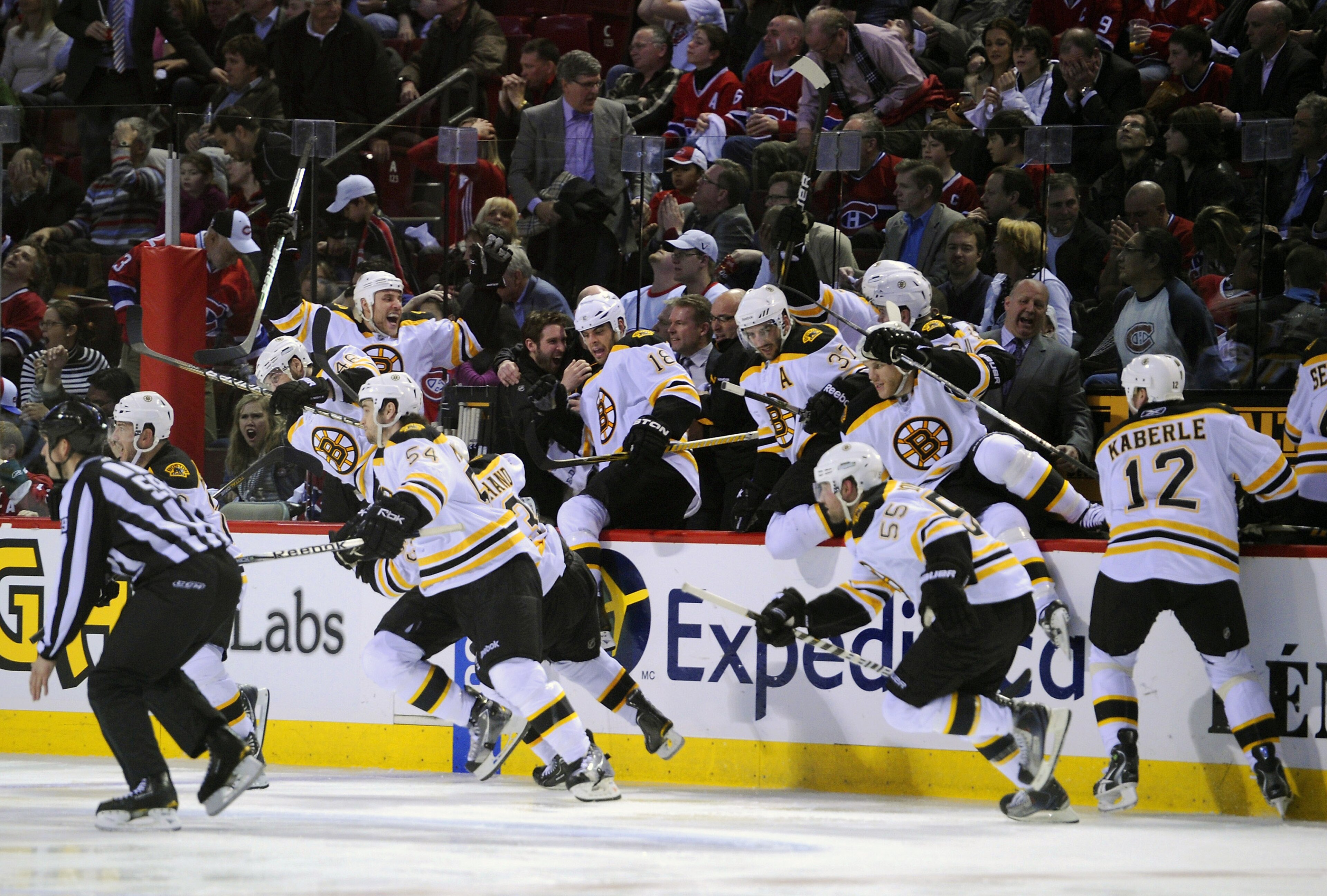 MONTREAL, QC - APRIL 21:  The Boston Bruins bench explodes onto the ice after defeating the Montreal Canadiens in overtime during Game Four of the Eastern Conference Quarterfinals during the 2011 NHL Stanley Cup Playoffs at the Bell Centre on April 21, 20