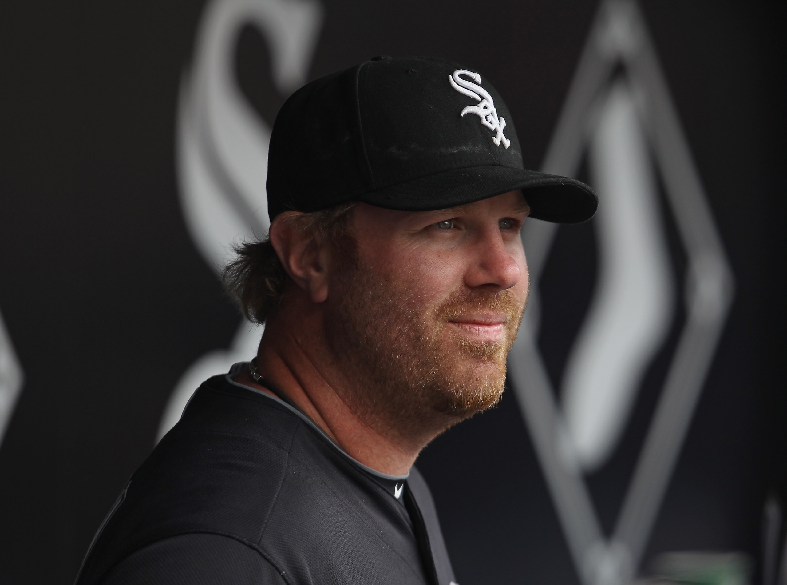 CHICAGO, IL - APRIL 07: Adam Dunn #32 of the Chicago White Sox waits in the dugout for player introductions before the home opener against the Tampa Bay Rays at U.S. Cellular Field on April 7, 2011 in Chicago, Illinois. The White Sox defeated the Rays 5-1