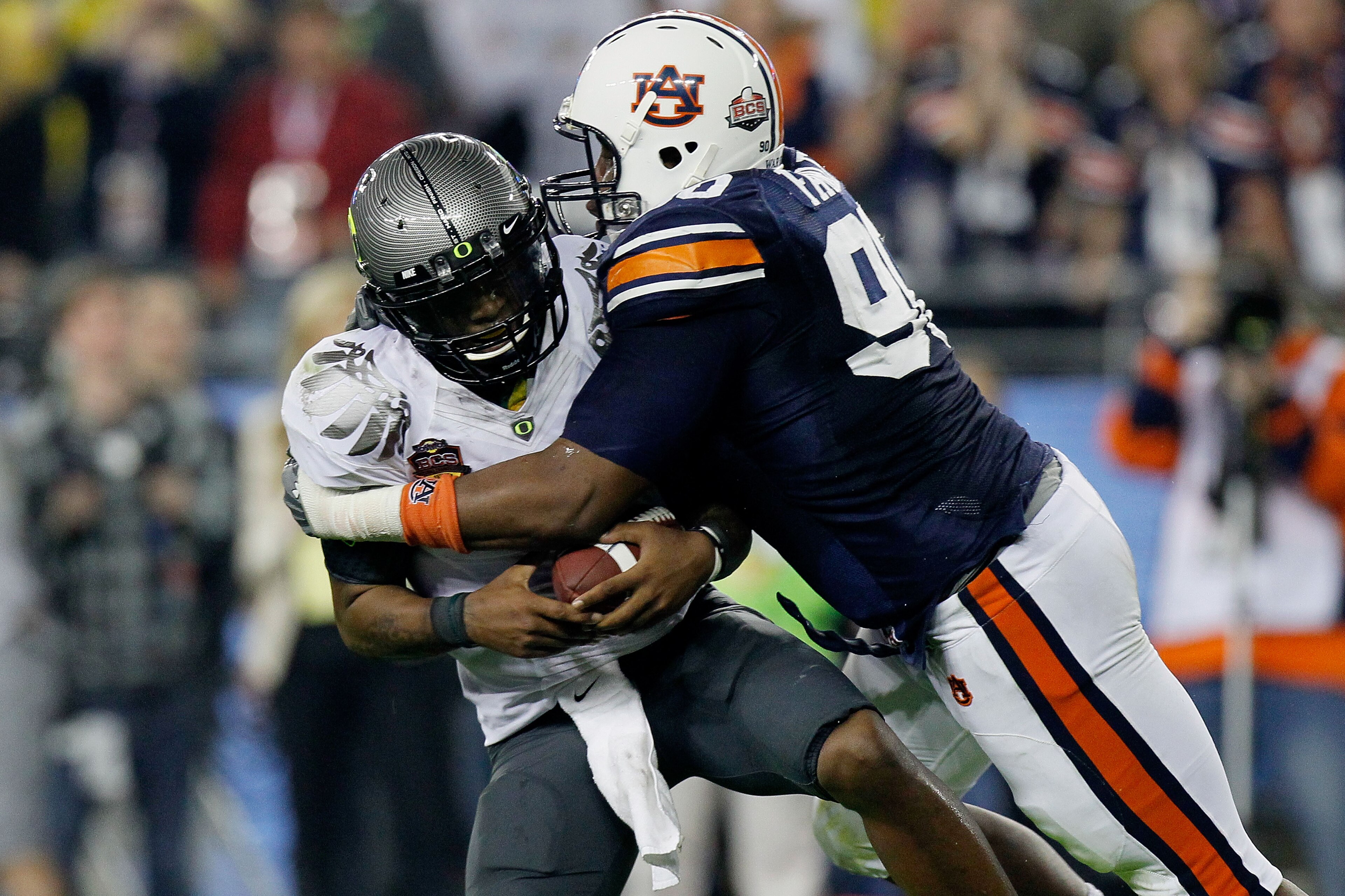 GLENDALE, AZ - JANUARY 10: Quarterback Darron Thomas #1 of the Oregon Ducks is sacked by Nick Fairley #90 of the Auburn Tigers in the first half in the Tostitos BCS National Championship Game at University of Phoenix Stadium on January 10, 2011 in Glenda GLENDALE, AZ - JANUARY 10: Quarterback Darron Thomas #1 of the Oregon Ducks is sacked by Nick Fairley #90 of the Auburn Tigers in the first half in the Tostitos BCS National Championship Game at University of Phoenix Stadium on January 10, 2011 in Glenda