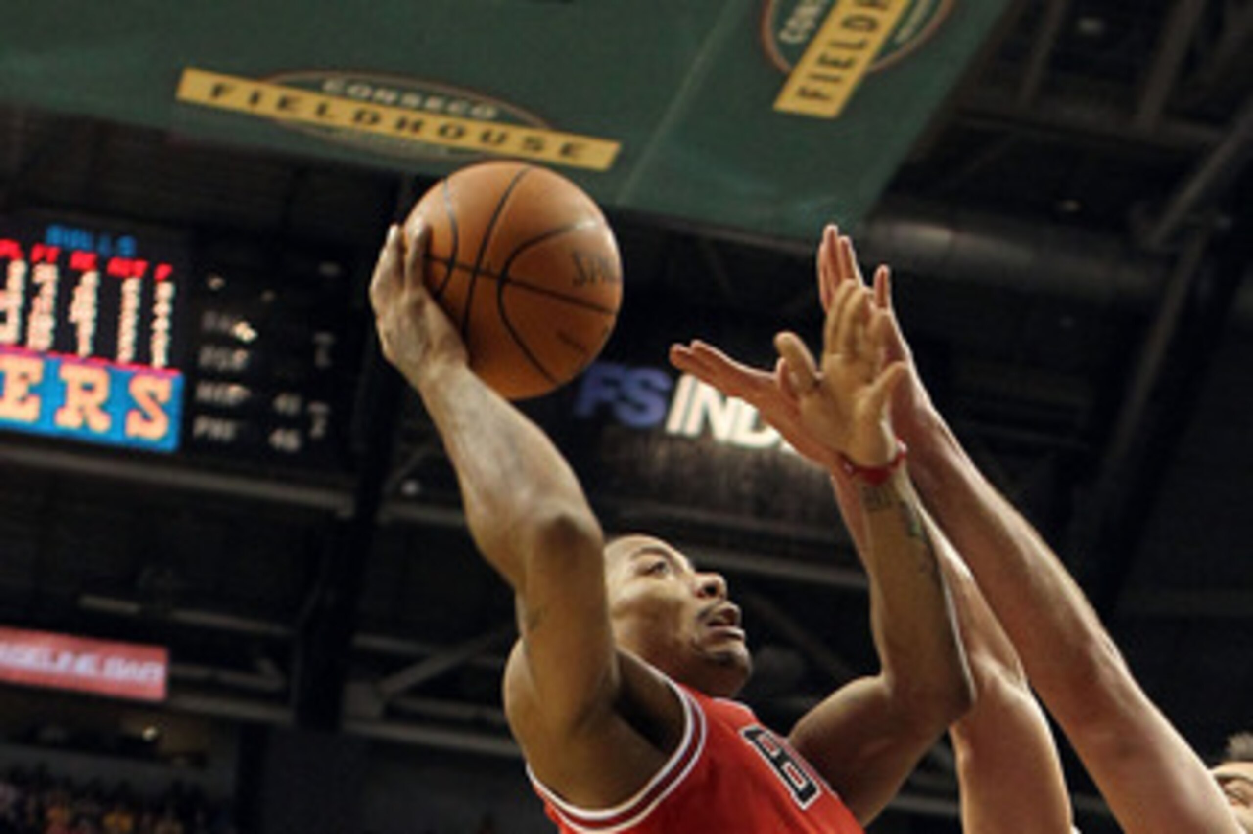 INDIANAPOLIS, IN - APRIL 21: Derrick Rose #1 of the Chicago Bulls shoots the ball while defended by Jeff Foster #10 of the Indiana Pacers in Game three of the Eastern Conference Quarterfinals in the 2011 NBA Playoffs on April 21, 2011 at Conseco Fieldho INDIANAPOLIS, IN - APRIL 21: Derrick Rose #1 of the Chicago Bulls shoots the ball while defended by Jeff Foster #10 of the Indiana Pacers in Game three of the Eastern Conference Quarterfinals in the 2011 NBA Playoffs on April 21, 2011 at Conseco Fieldho
