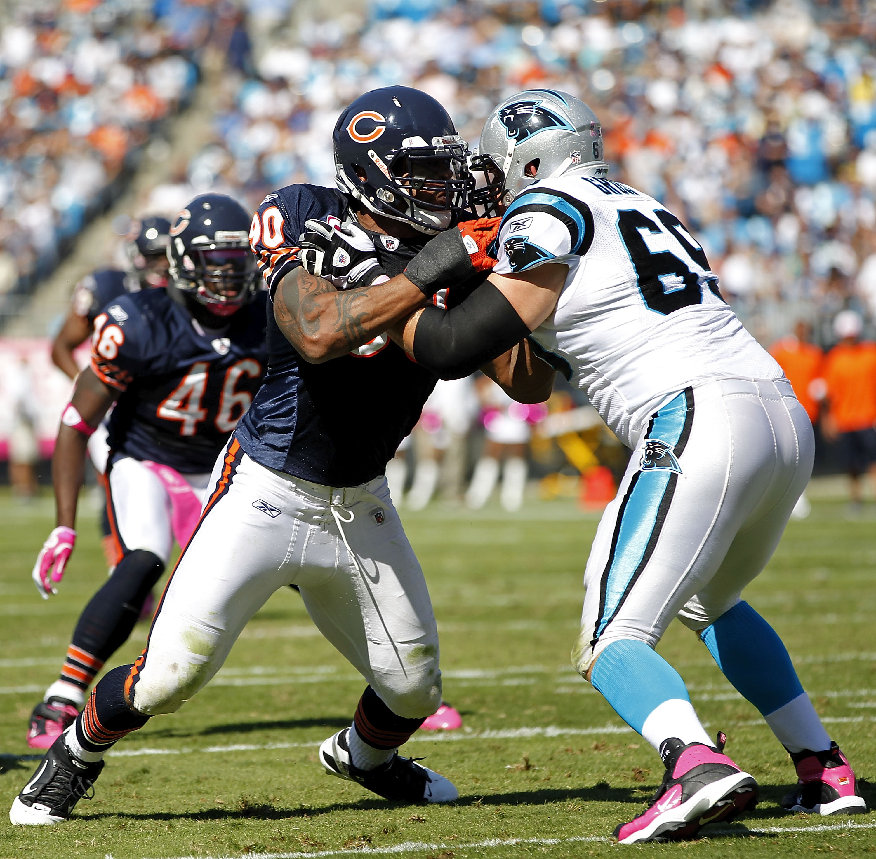 CHARLOTTE, NC - OCTOBER 10: Offensive tackle Jordan Gross #69 of the Carolina Panthers blocks defensive end Julius Peppers #90 of the Chicago Bears at Bank of America Stadium on October 10, 2010 in Charlotte, North Carolina. (Photo by Geoff Burke/Getty Im