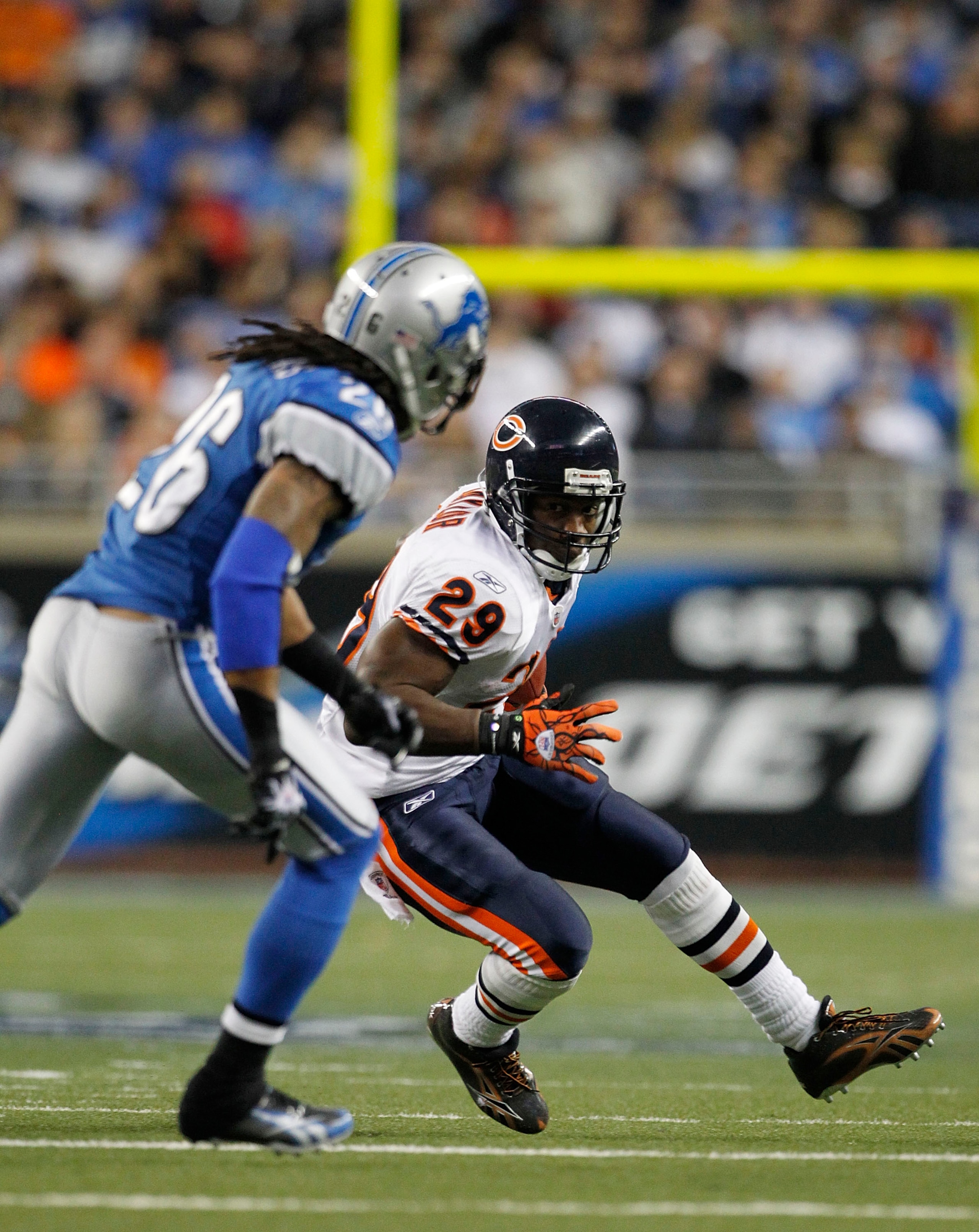 DETROIT - DECEMBER 05: Chester Taylor #29 of the Chicago Bears runs for a first down as Louis Delmas #26 of the Detroit Lions defends during the game at Ford Field on December 5, 2010 in Detroit, Michigan. The Bears defeated the Lions 24-20.  (Photo by Le