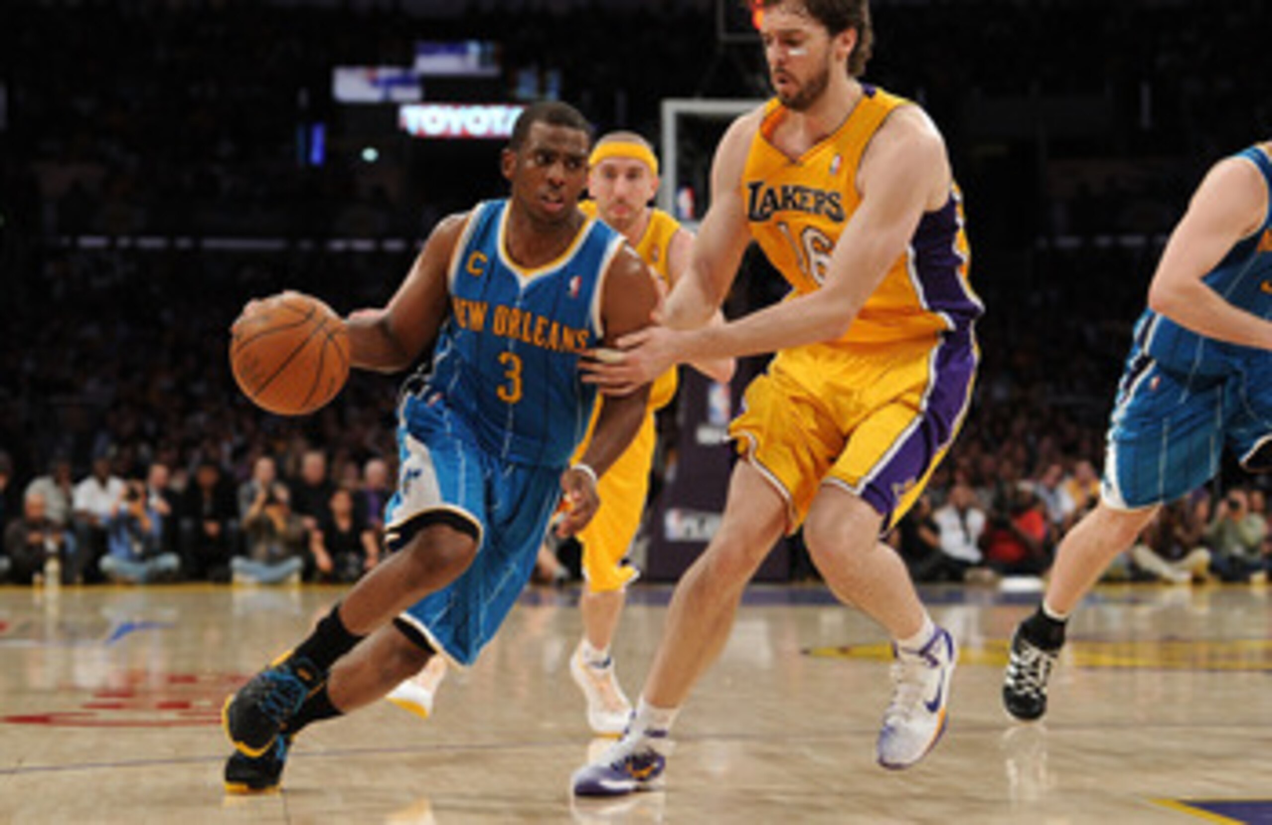 LOS ANGELES, CA - APRIL 20:  Chris Paul #3 of the New Orleans Hornets drives on Pau Gasol #16 of the Los Angeles Lakers in Game Two of the Western Conference Quarterfinals in the 2011 NBA Playoffs on April 20, 2011 at Staples Center in Los Angeles, Califo