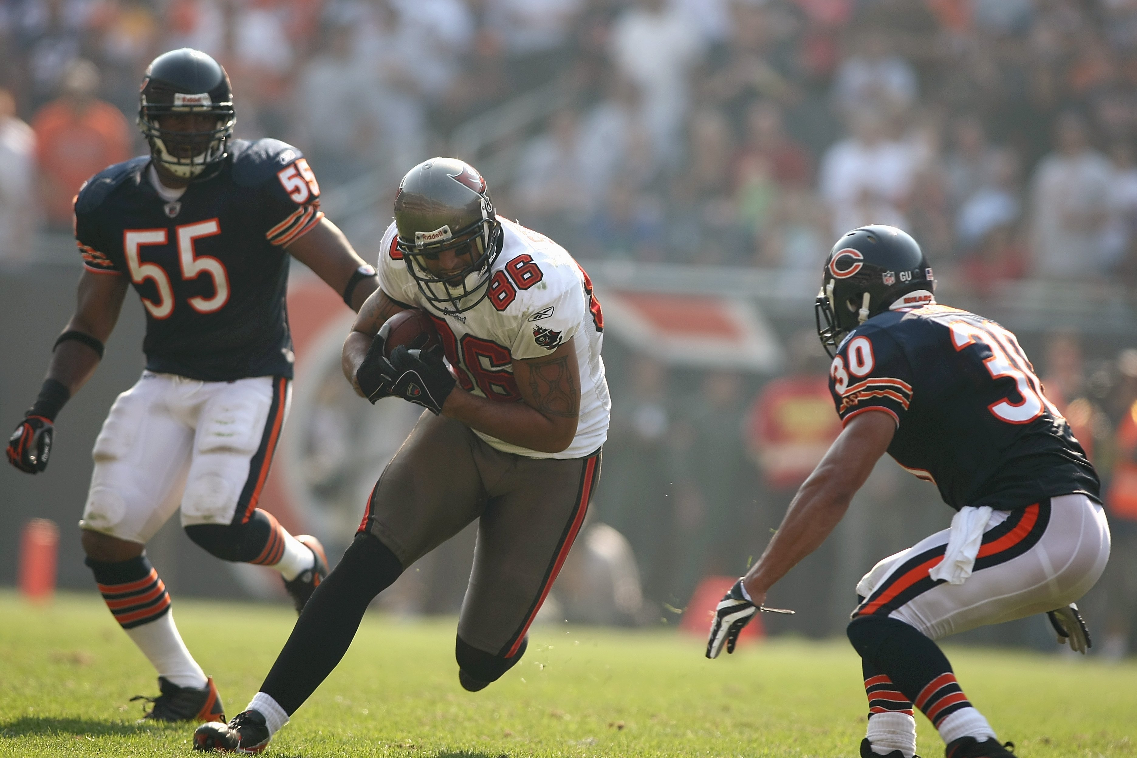 CHICAGO - SEPTEMBER 21:  Jerramy Stevens #86 of the Tampa Bay Buccaneers runs with the ball against Mike Brown #30 of the Chicago Bears at Soldier Field on September 21, 2008 in Chicago, Illinois. The Buccaneers won 27-24 in OT. (Photo by Jonathan Ferrey/